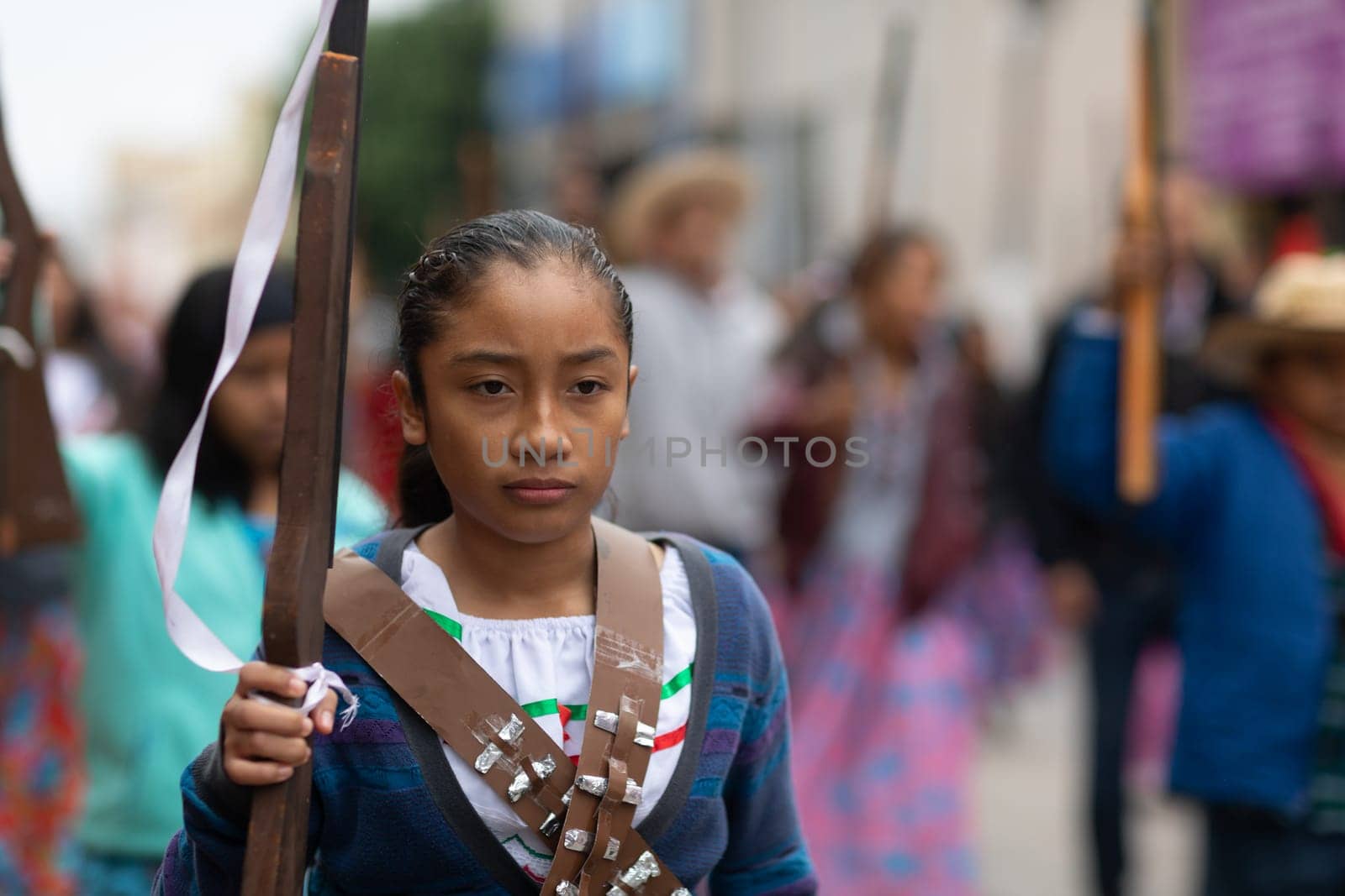 Matamoros, Tamaulipas, Mexico - November 20, 2018: The November 20 Parade, Young Girl wearing traditional clothing Holding a toy rifle at the parade