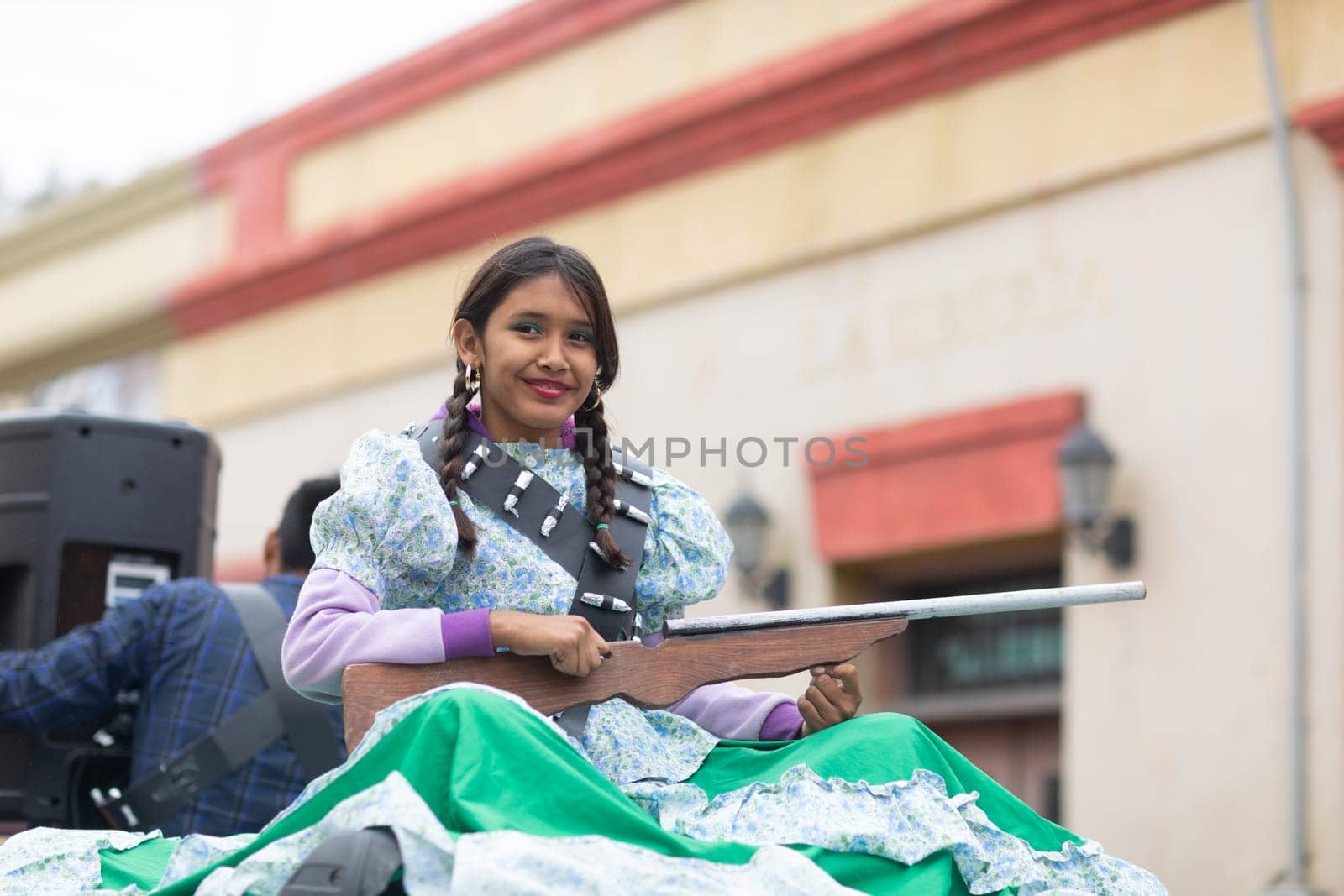 Matamoros, Tamaulipas, Mexico - November 20, 2018: The November 20 Parade, Young Girl wearing traditional clothing Holding a toy rifle at the parade