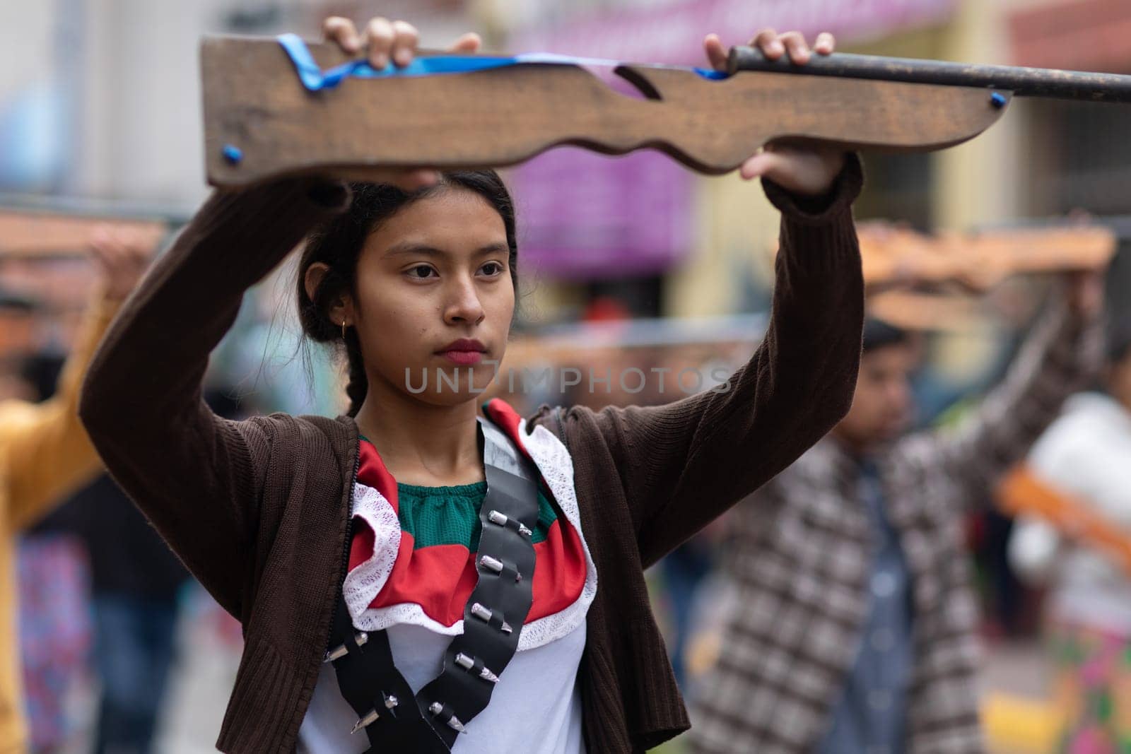 Matamoros, Tamaulipas, Mexico - November 20, 2018: The November 20 Parade, Young Girl wearing traditional clothing Holding a toy rifle at the parade