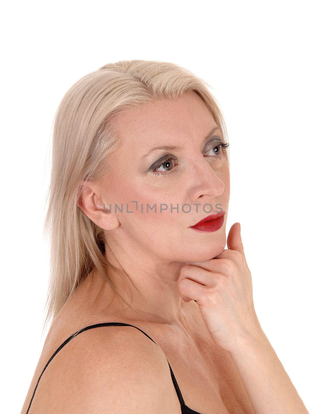 A gorgeous blond woman with red lips and her hand under her chin,.looking away, isolated for white background.