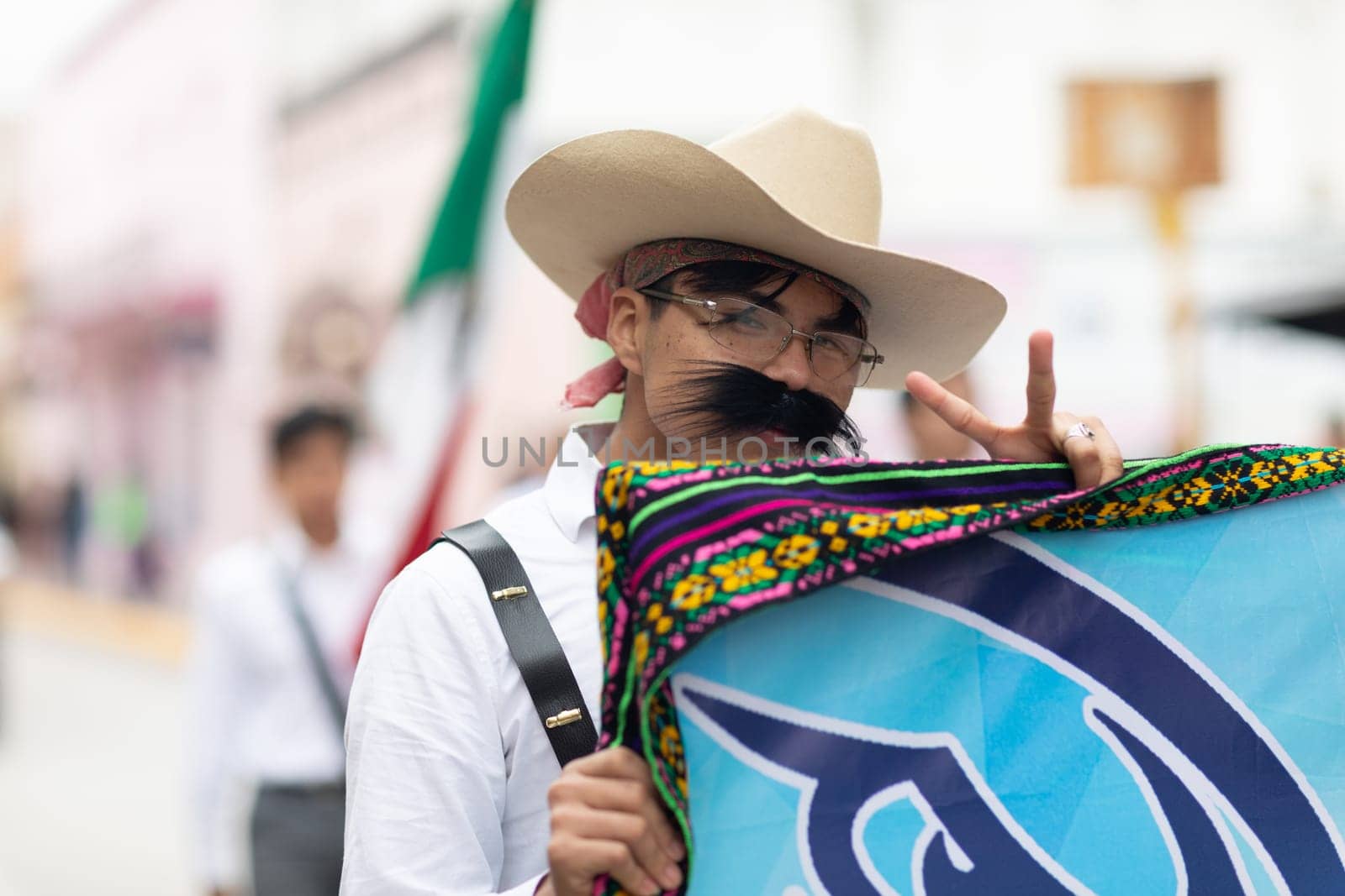 Matamoros, Tamaulipas, Mexico - November 20, 2018: The November 20 Parade, Young man wearing traditional mexican clothing with a sombrero giving the peace sign