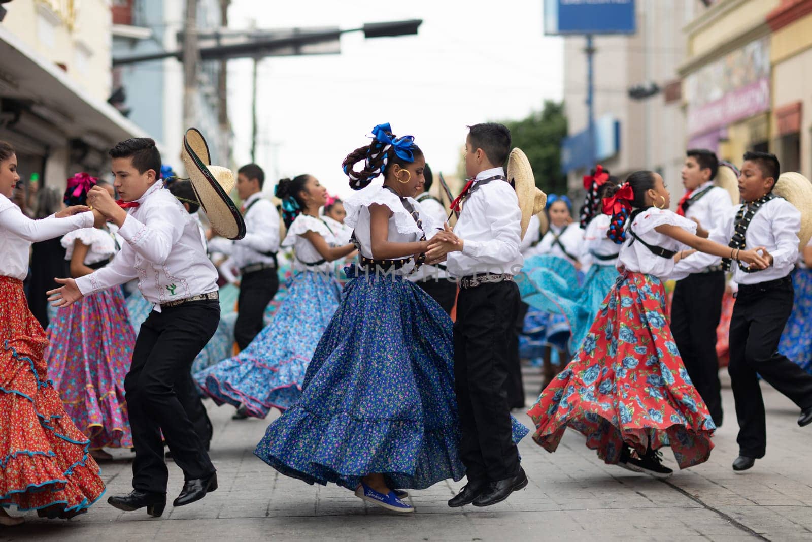 Matamoros, Tamaulipas, Mexico - November 20, 2018: The November 20 Parade, Young women and men dancing wearing traditional mexican clothing during the parade