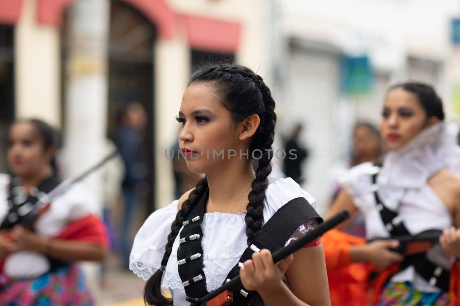 Matamoros, Tamaulipas, Mexico - November 20, 2018: The November 20 Parade, Young Girl wearing traditional clothing Holding a toy rifle at the parade