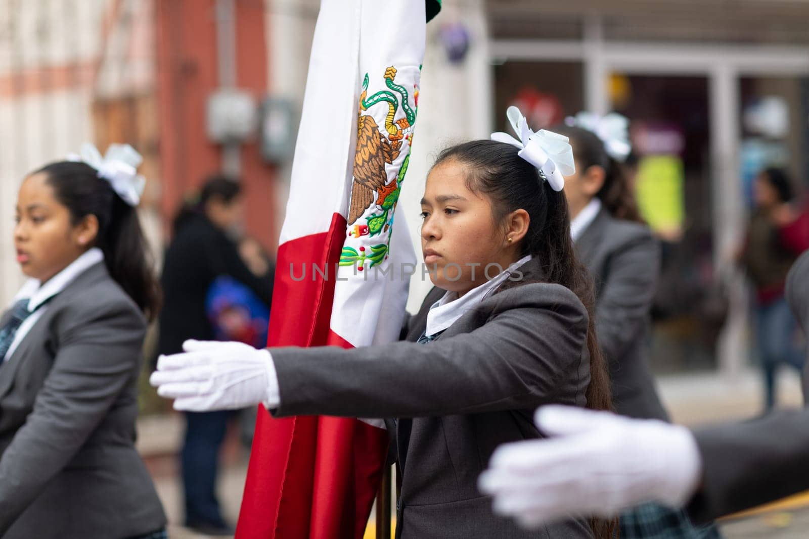 Matamoros, Tamaulipas, Mexico - November 20, 2018: The November 20 Parade, Female Students scorting the mexican flag down the street
