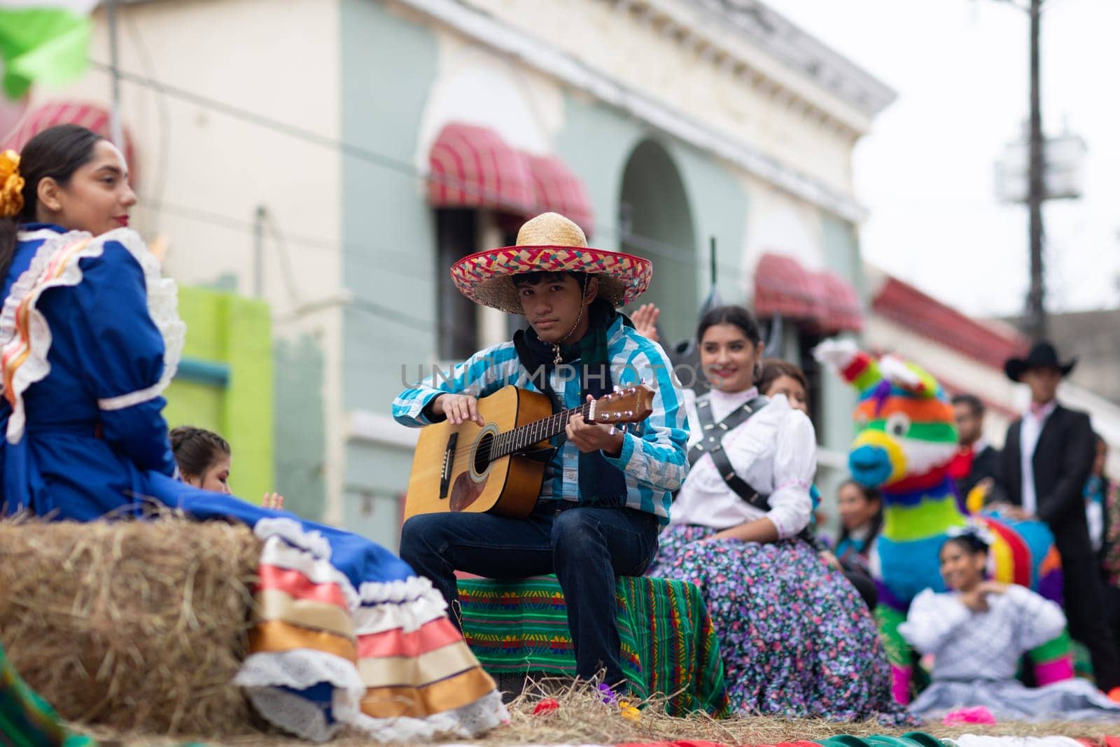 Matamoros, Tamaulipas, Mexico - November 20, 2018: The November 20 Parade, Young mexican man playing the guitar on a float