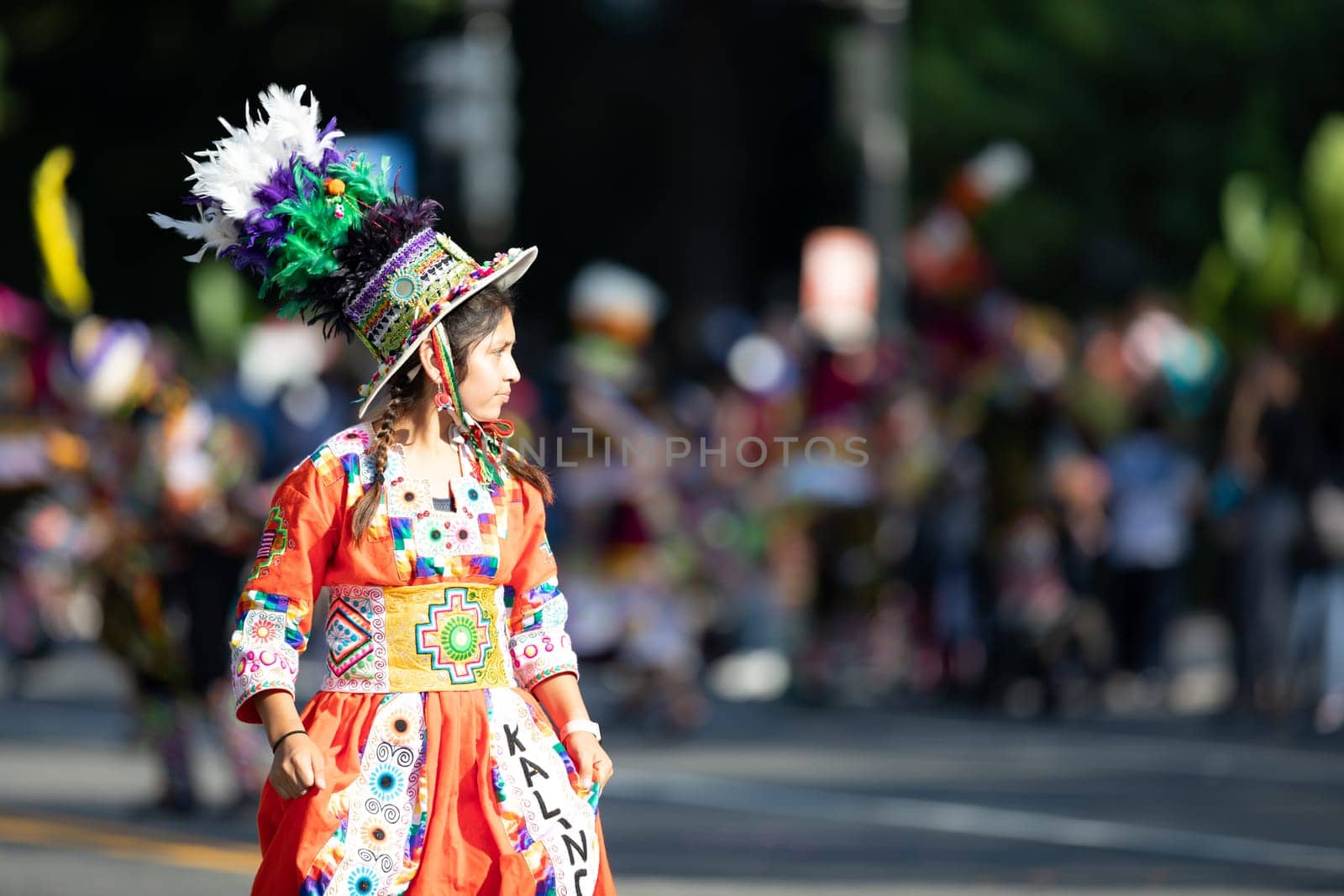 Washington, D.C., USA - September 29, 2018: The Fiesta DC Parade, Young Bolivian girl wearing traditional clothing going down the street during the parade