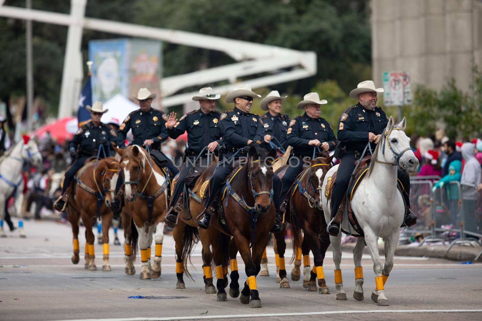 Houston, Texas, USA - November 22, 2018 The H-E-B Thanksgiving Day Parade, Sheriff riding horses waving at spectators, during the parade