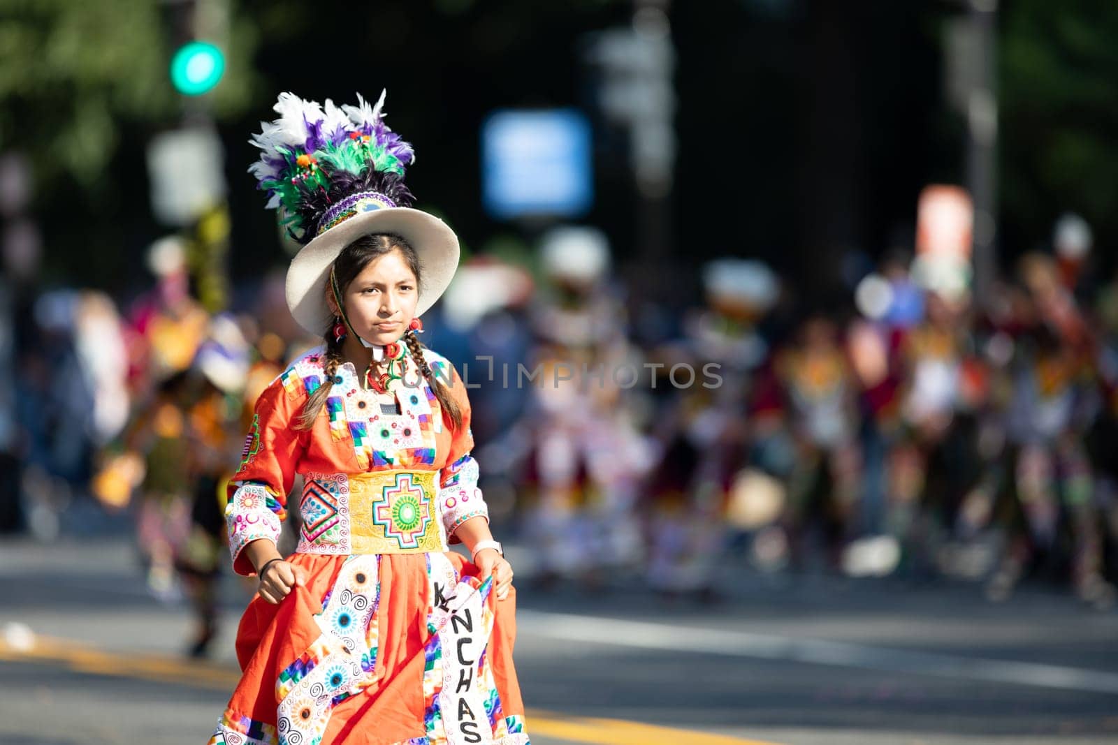 Washington, D.C., USA - September 29, 2018: The Fiesta DC Parade, Young Bolivian girl wearing traditional clothing going down the street during the parade