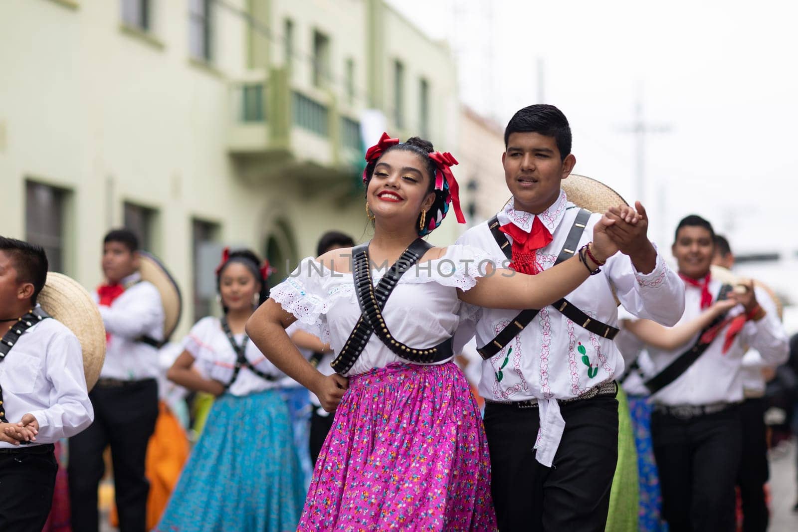 Matamoros, Tamaulipas, Mexico - November 20, 2018: The November 20 Parade, Young women and men dancing wearing traditional mexican clothing during the parade