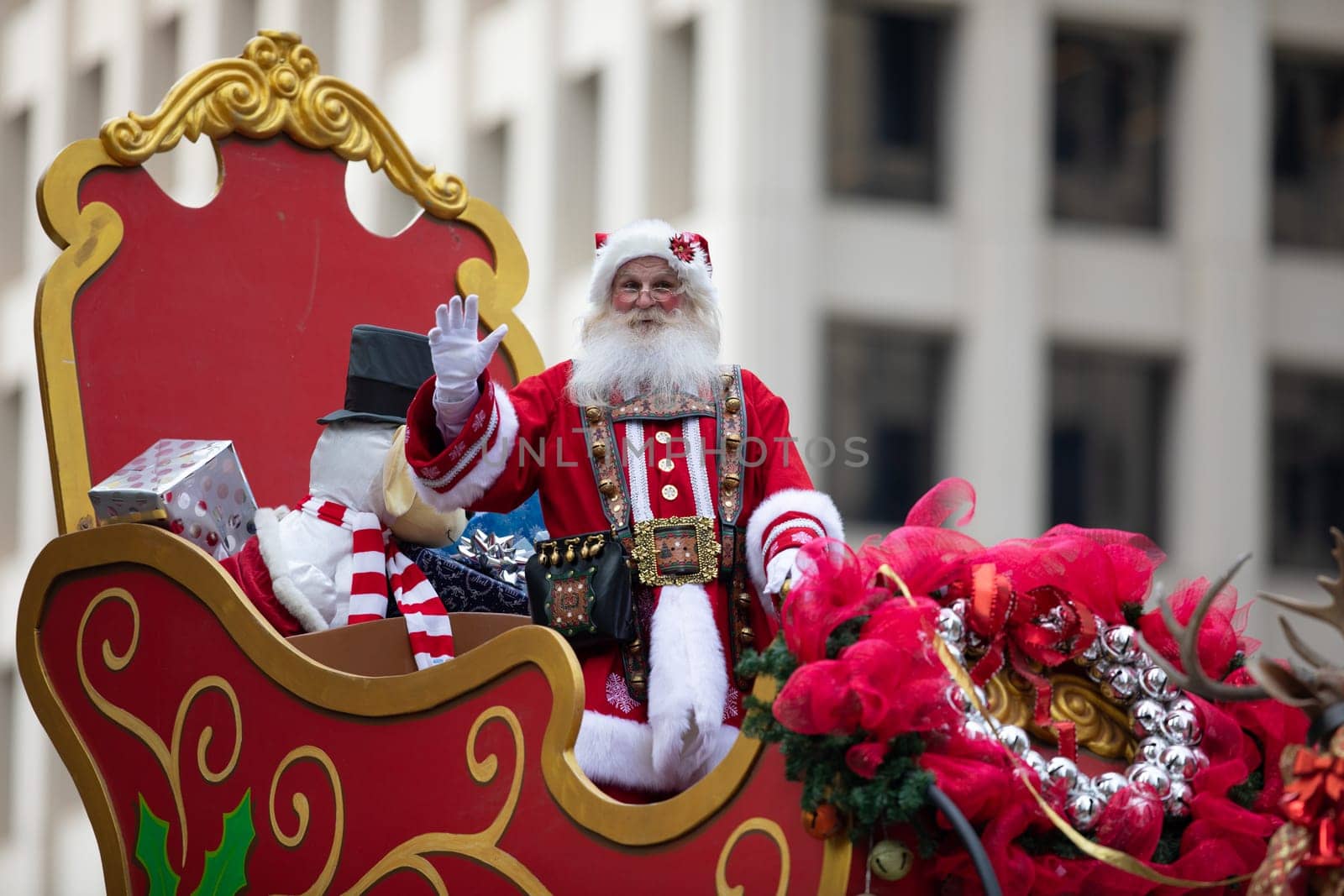 Houston, Texas, USA - November 22, 2018 The H-E-B Thanksgiving Day Parade, Man dress up as Santa Claus, riding a sleigh and waving at people, with presents