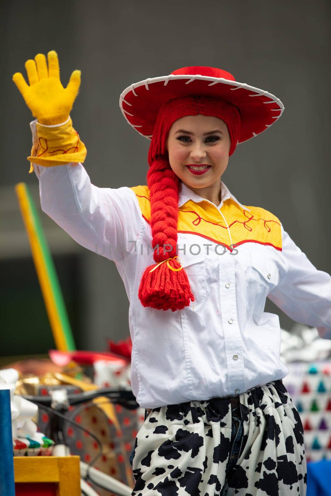 Houston, Texas, USA - November 22, 2018 The H-E-B Thanksgiving Day Parade, Woman on a float waving at people dress up as Jessie Toy Story Character