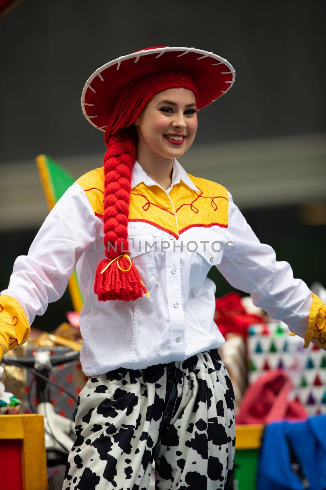 Houston, Texas, USA - November 22, 2018 The H-E-B Thanksgiving Day Parade, Woman on a float waving at people dress up as Jessie Toy Story Character