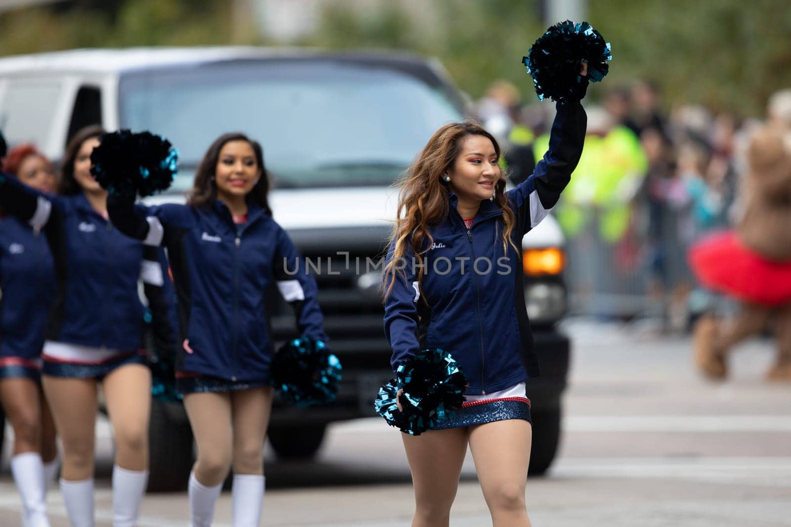 Houston, Texas, USA - November 22, 2018 The H-E-B Thanksgiving Day Parade, Ed-U-Gator and cheerleaders from the university of Houston, walking down the street during the parade