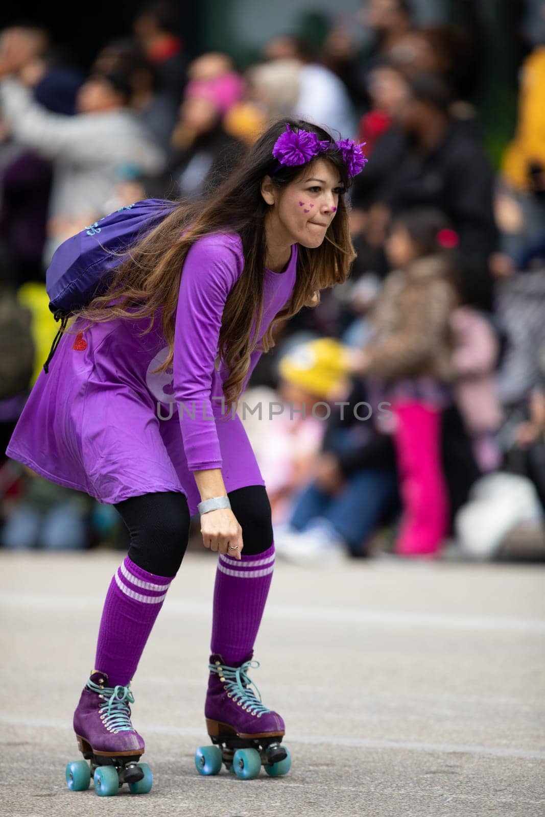 Houston, Texas, USA - November 22, 2018 The H-E-B Thanksgiving Day Parade, Woman wearing a colorful purple dress using roller skates during the parade.