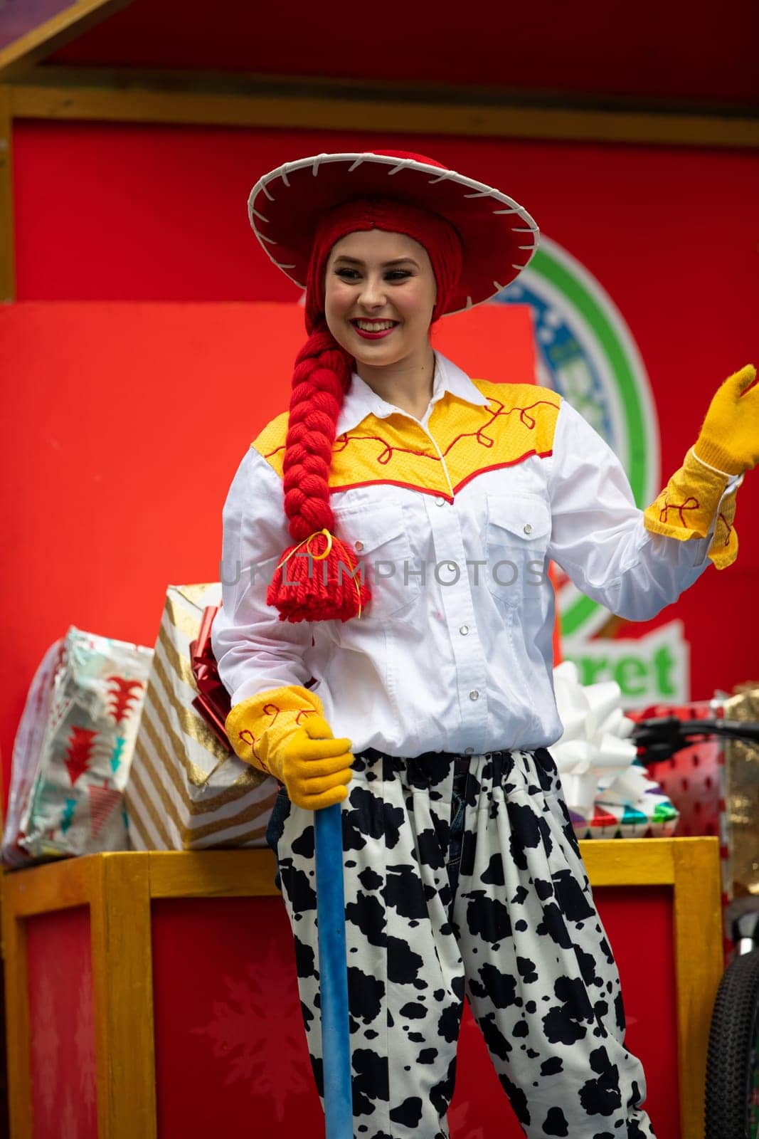 Houston, Texas, USA - November 22, 2018 The H-E-B Thanksgiving Day Parade, Woman on a float waving at people dress up as Jessie Toy Story Character
