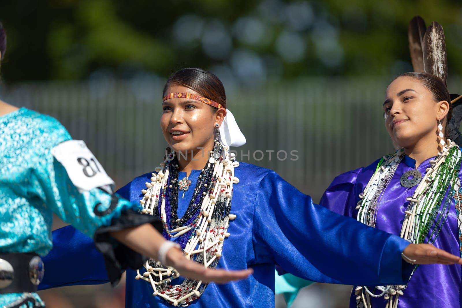 Milwaukee, Wisconsin, USA - September 8, 2018 The Indian Summer Festival, Young woman wearing traditional native american clothing, dancing at the pow wow competition.