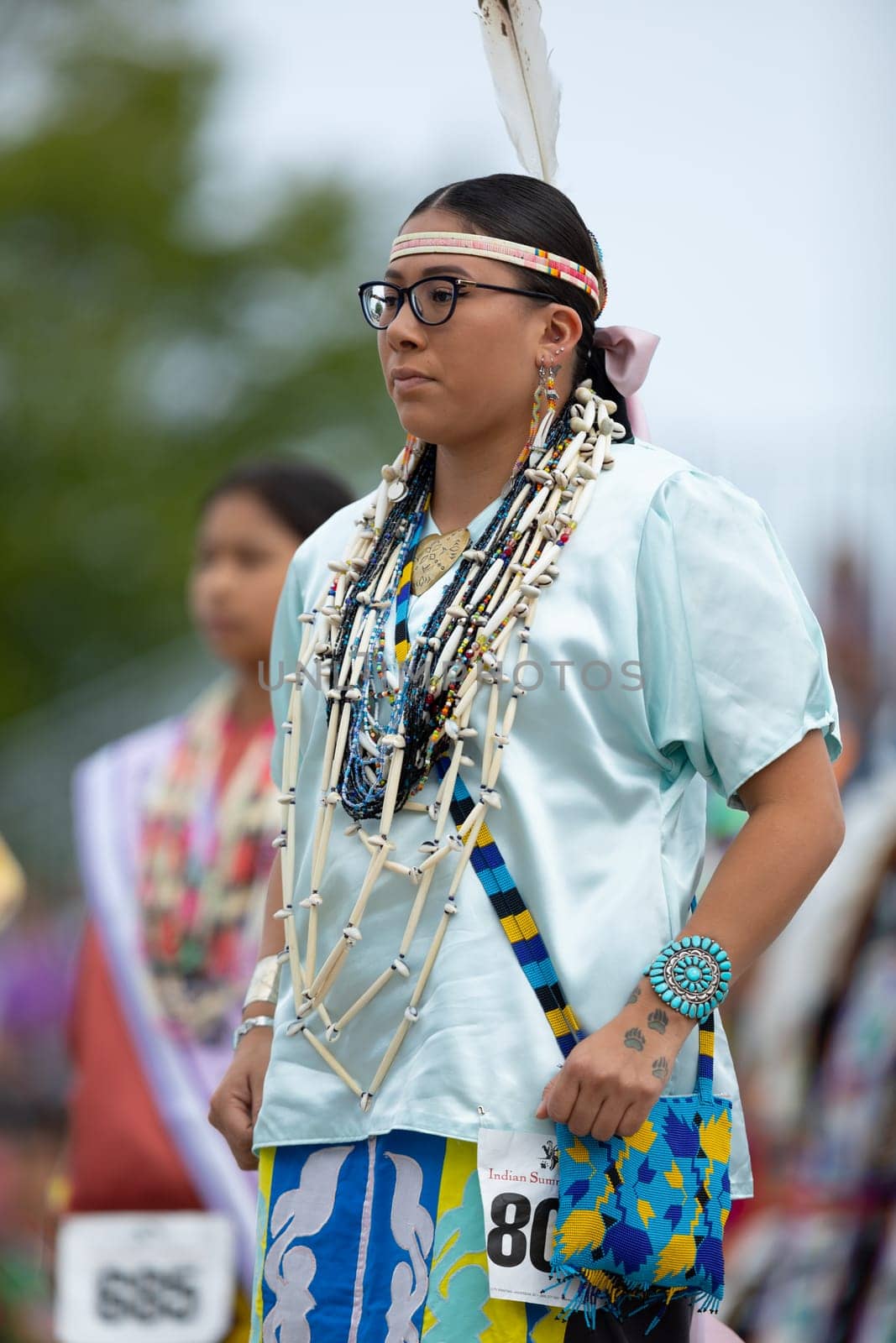 Milwaukee, Wisconsin, USA - September 8, 2018 The Indian Summer Festival Young woman wearing traditional native american clothing at the pow wow competition.