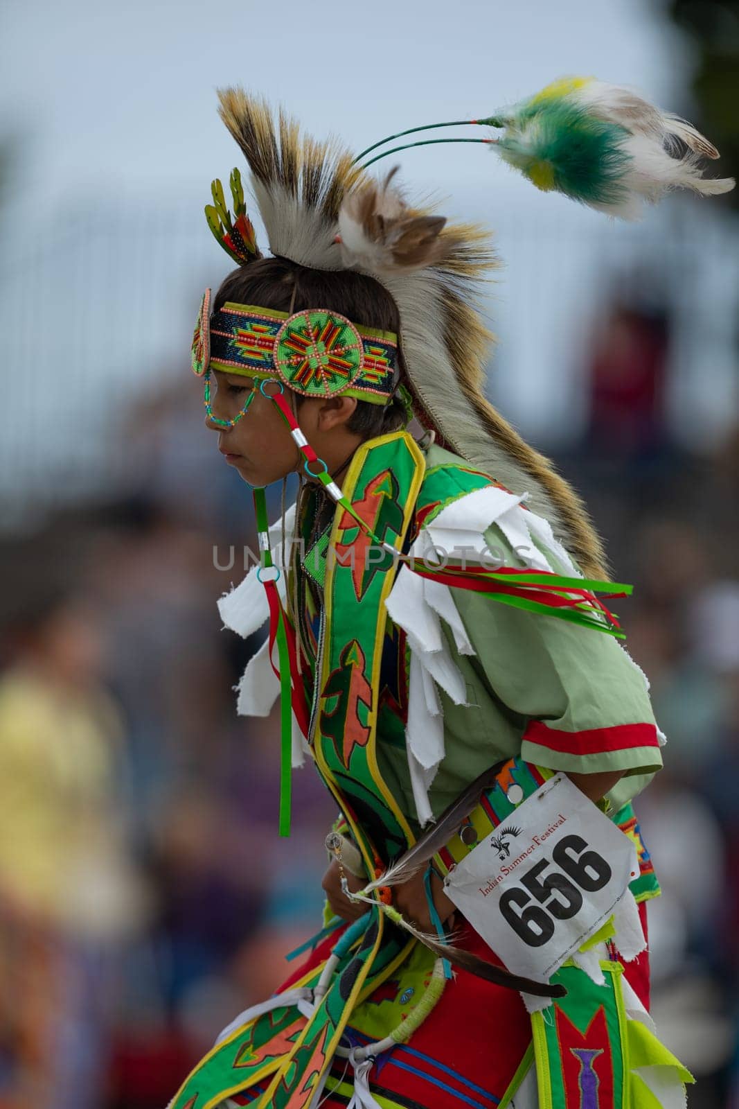 Milwaukee, Wisconsin, USA - September 8, 2018 The Indian Summer Festival, Child wearing traditional native american clothing, dancing at the pow wow competition.