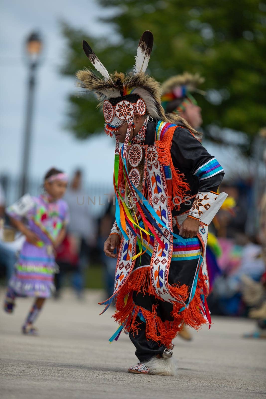 Milwaukee, Wisconsin, USA - September 8, 2018 The Indian Summer Festival, Man wearing traditional native american clothing, dancing at the pow wow competition.