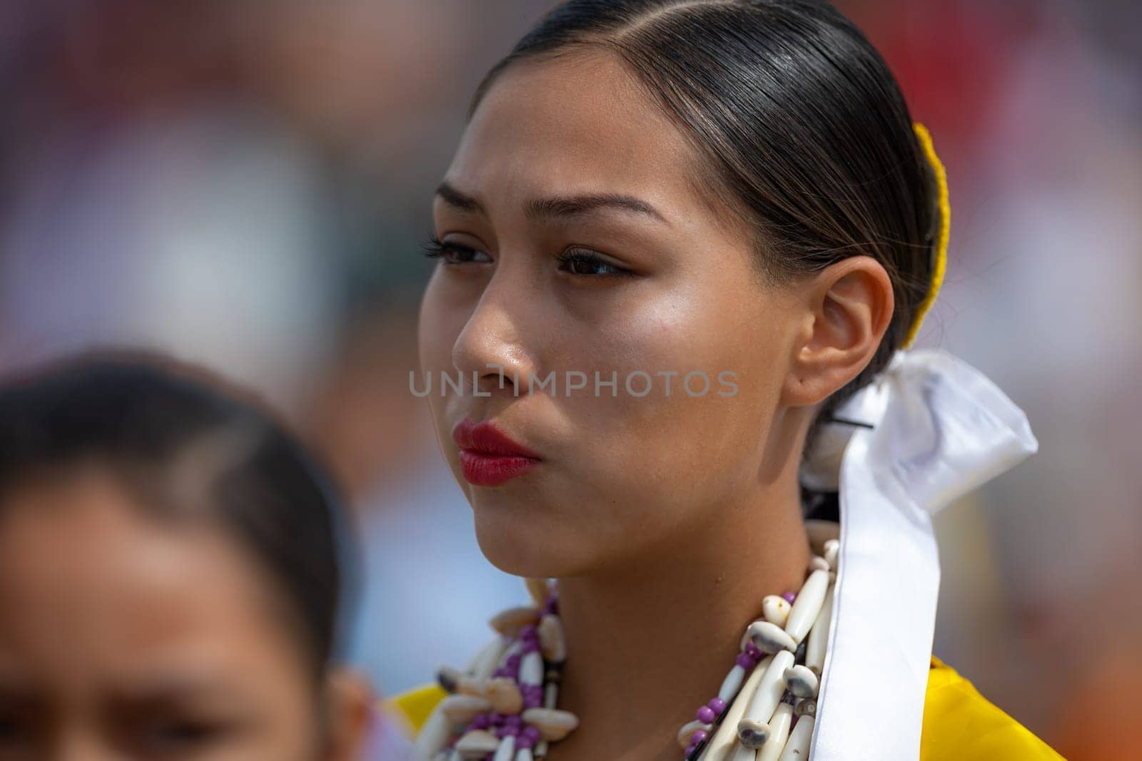 Milwaukee, Wisconsin, USA - September 8, 2018 The Indian Summer Festival Young woman wearing traditional native american clothing at the pow wow competition.