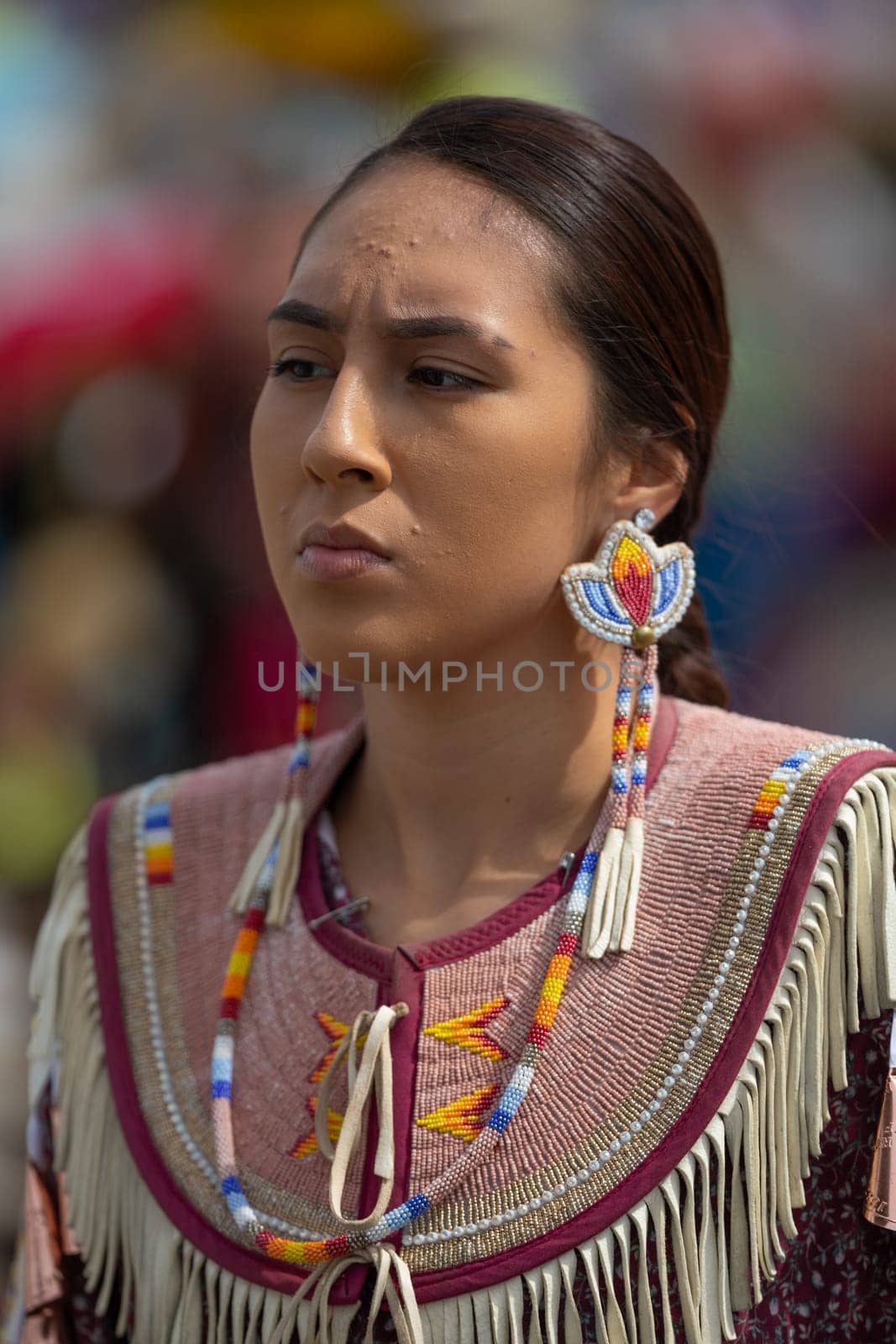 Milwaukee, Wisconsin, USA - September 8, 2018 The Indian Summer Festival Young woman wearing traditional native american clothing at the pow wow competition.