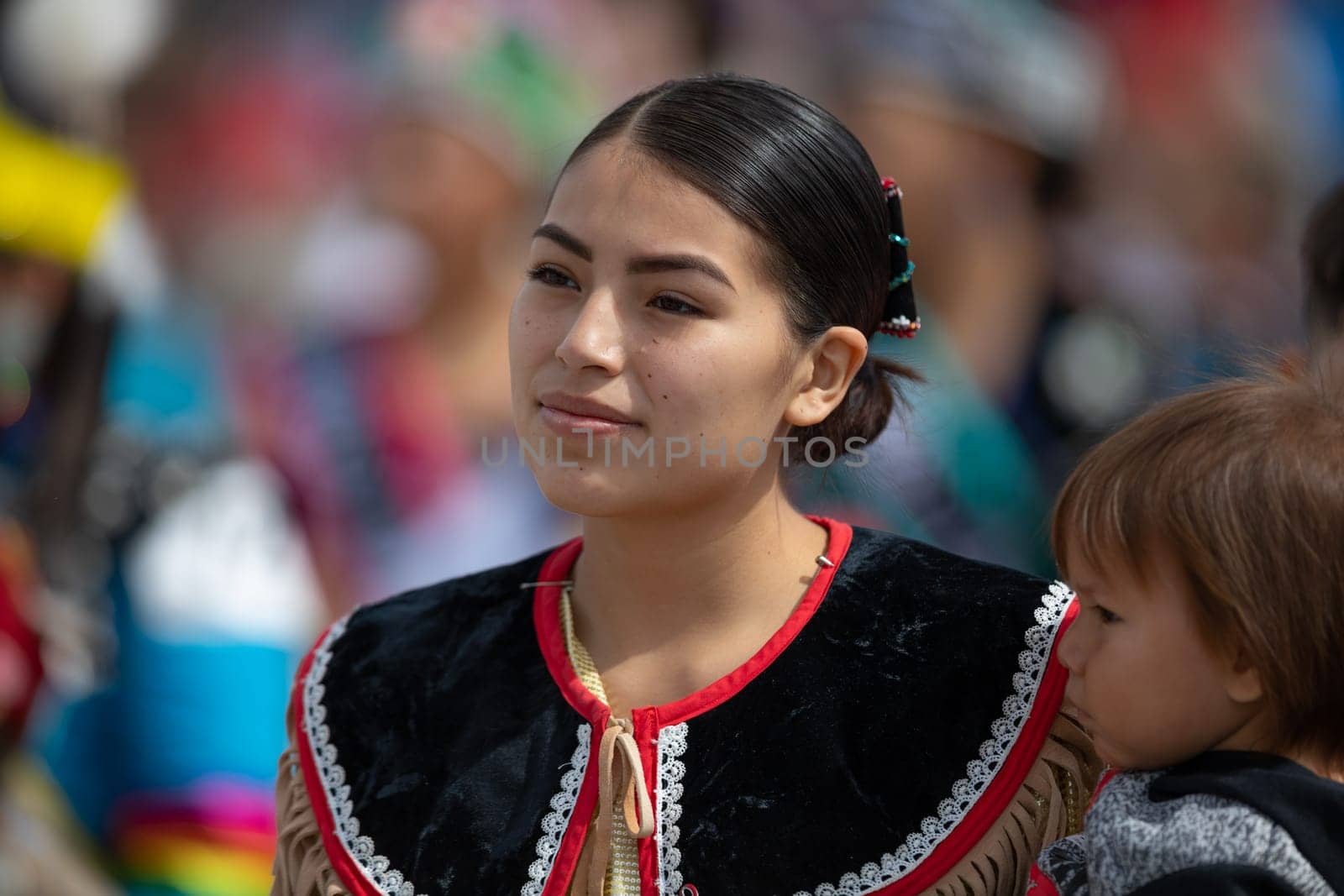 Milwaukee, Wisconsin, USA - September 8, 2018 The Indian Summer Festival Young woman wearing traditional native american clothing at the pow wow competition.