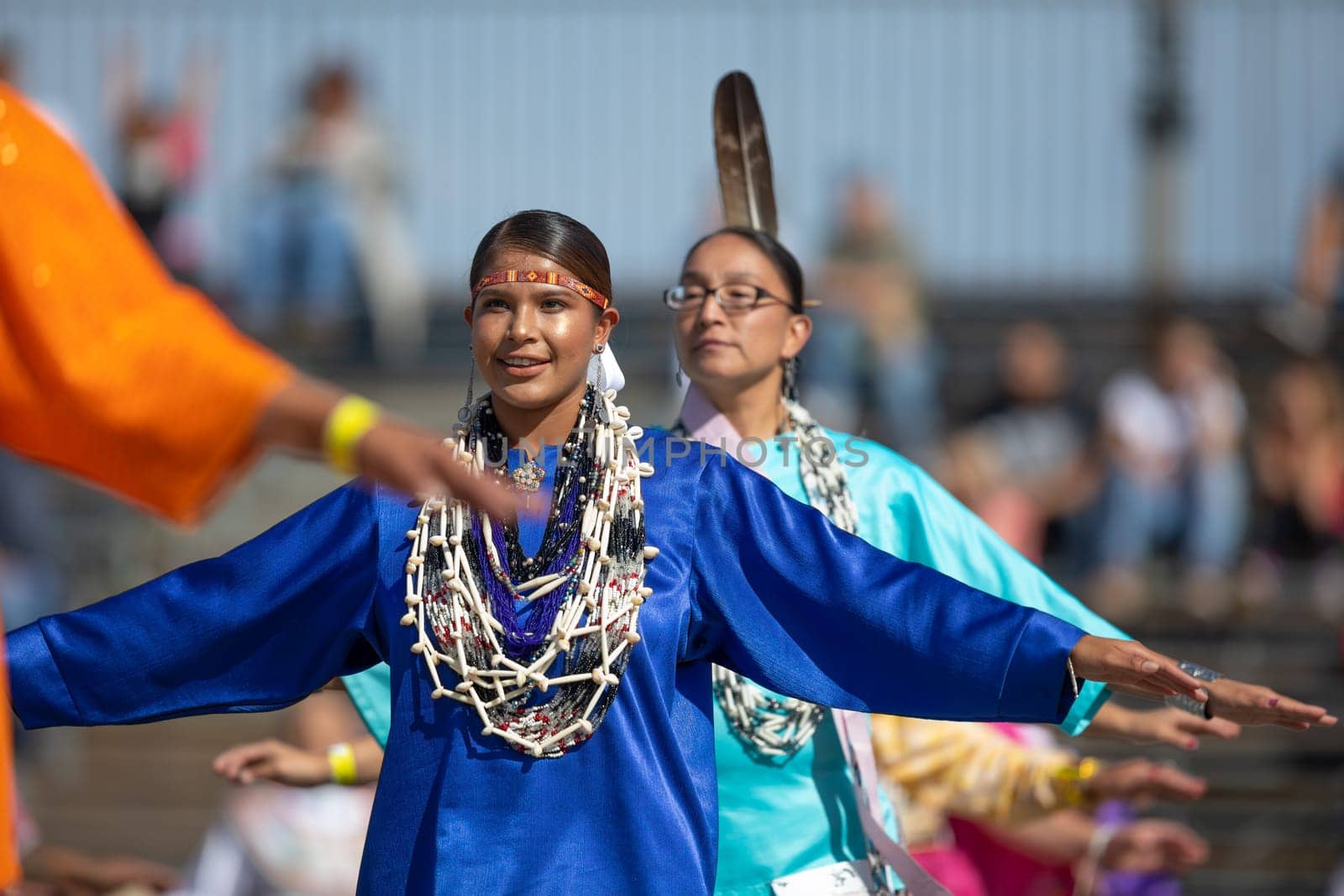 Milwaukee, Wisconsin, USA - September 8, 2018 The Indian Summer Festival, Young woman wearing traditional native american clothing, dancing at the pow wow competition.