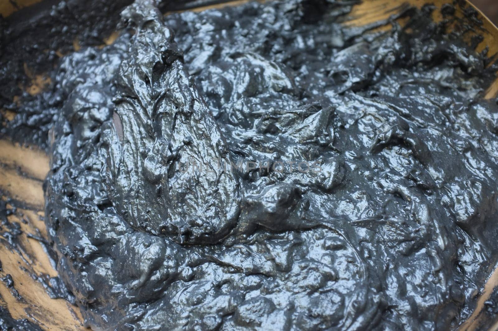 Cooking Scene of BLACK COCONUT SWEET PUDDING in Brass pot (KANOM PIAKPOON) . Thai sweetmeat