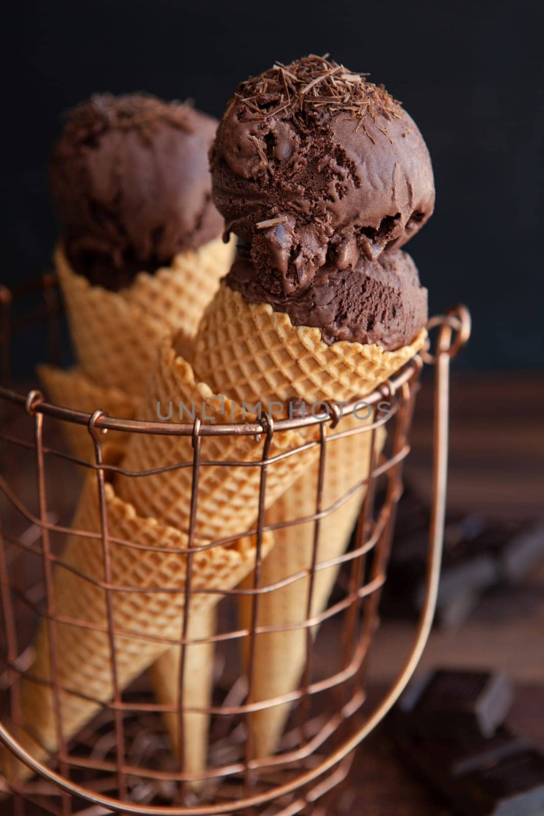 Waffled cones in basket with rich dark chocolate ice cream