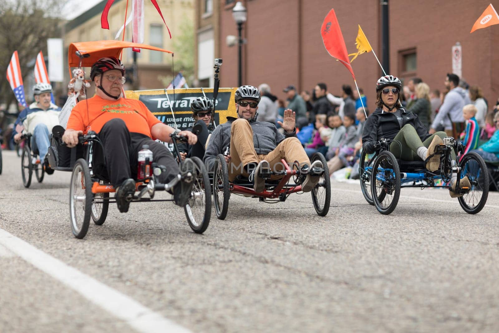 Holland, Michigan, USA - May 12, 2018 People riding trikes down the road at the Muziek Parade, during the Tulip Time Festival