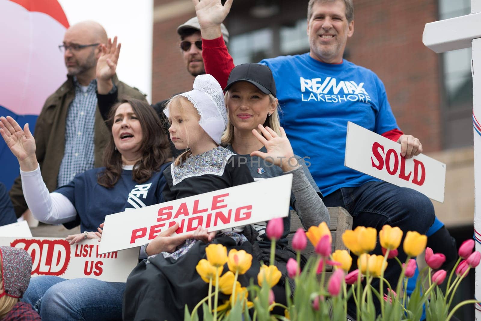 Holland, Michigan, USA - May 12, 2018 Float promoting Re/Max  with a hot air balloon and people holding signs that say, sold, sale pending at the Muziek Parade, during the Tulip Time Festival