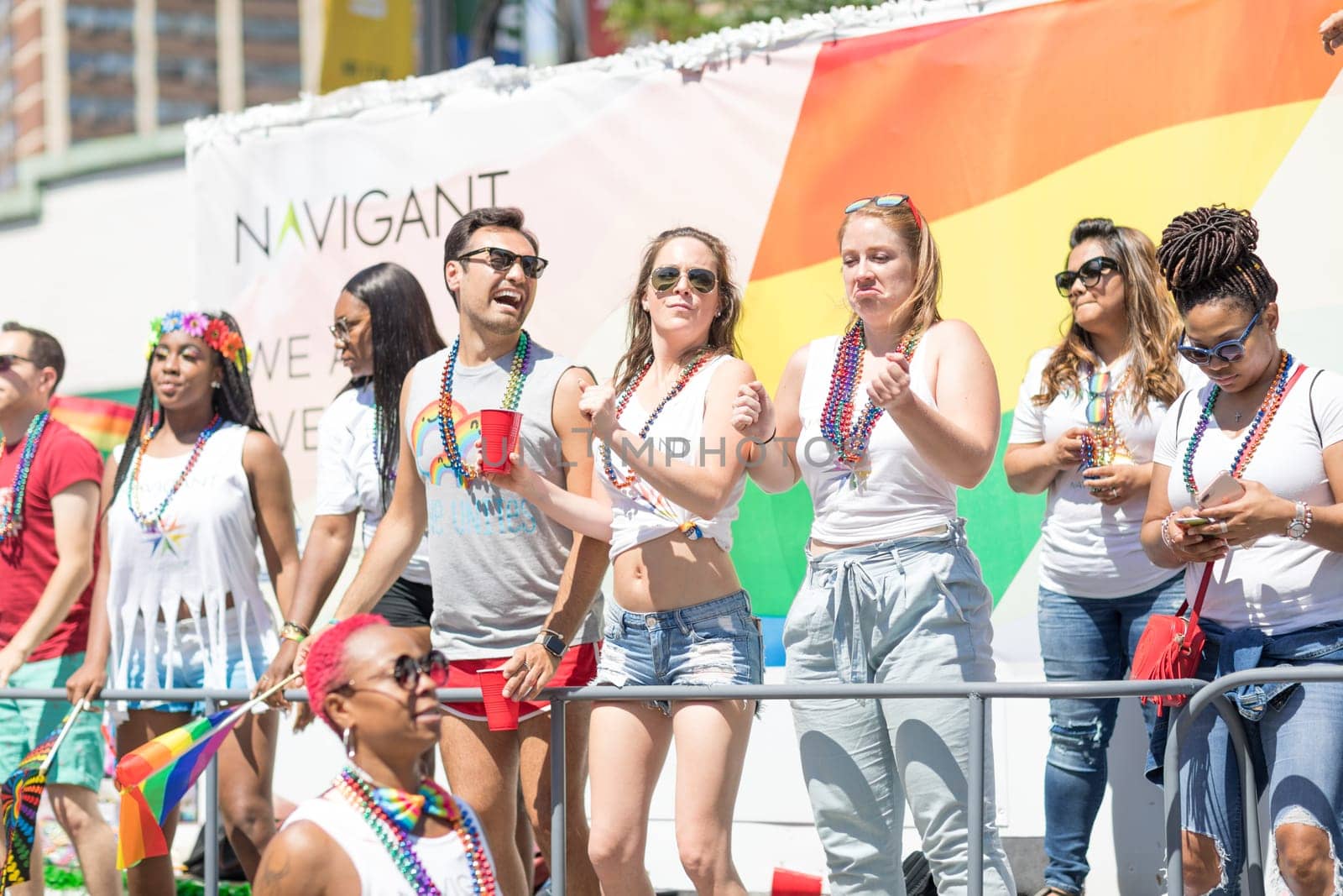 Chicago, Illinois, USA - June 24, 2018: the LGBTQ Pride Parade, Men and women promoting Navigant during the parade