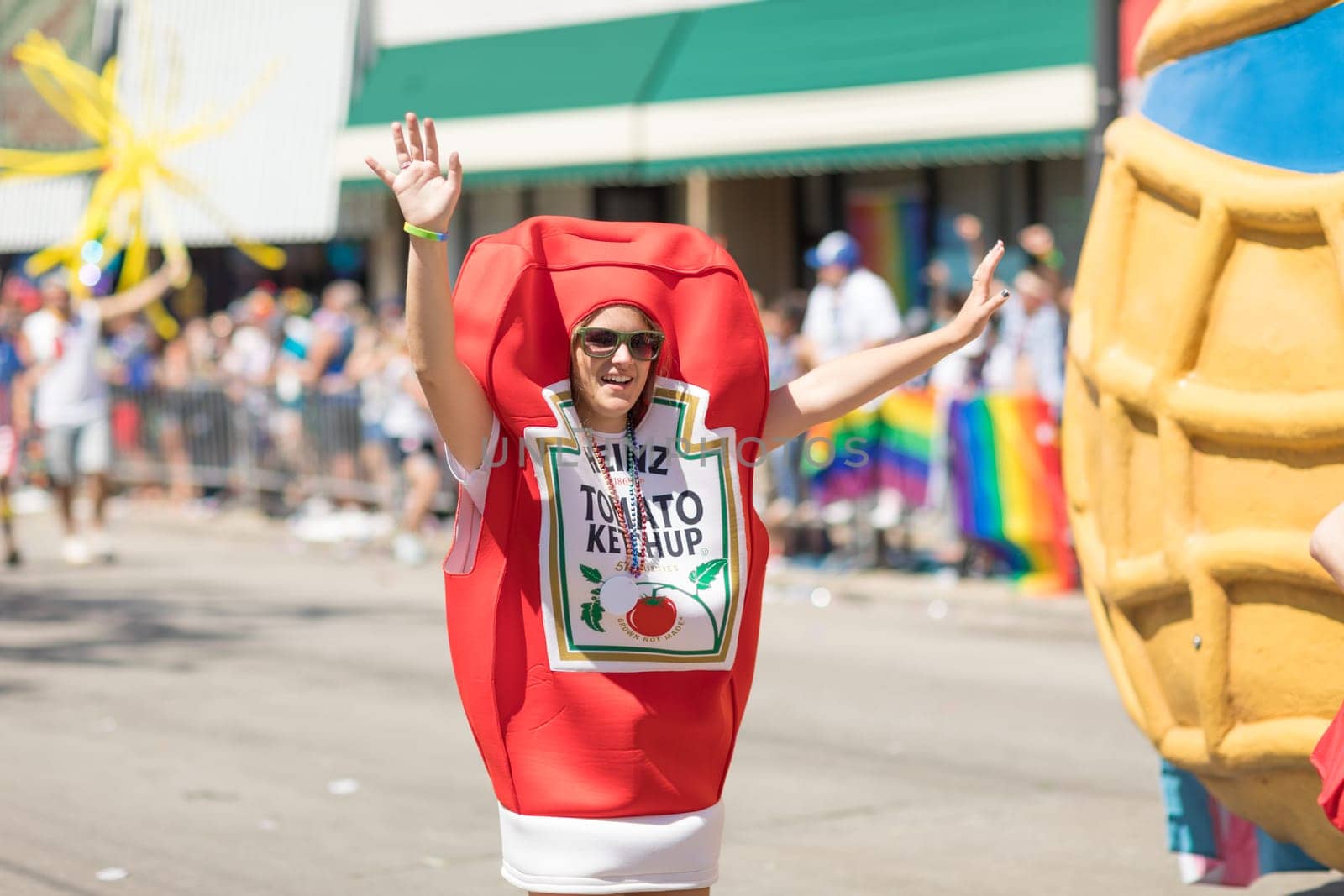 Chicago, Illinois, USA - June 24, 2018: the LGBTQ Pride Parade, Woman dress up as Heinz Tomato Ketchup Bottle during the parade