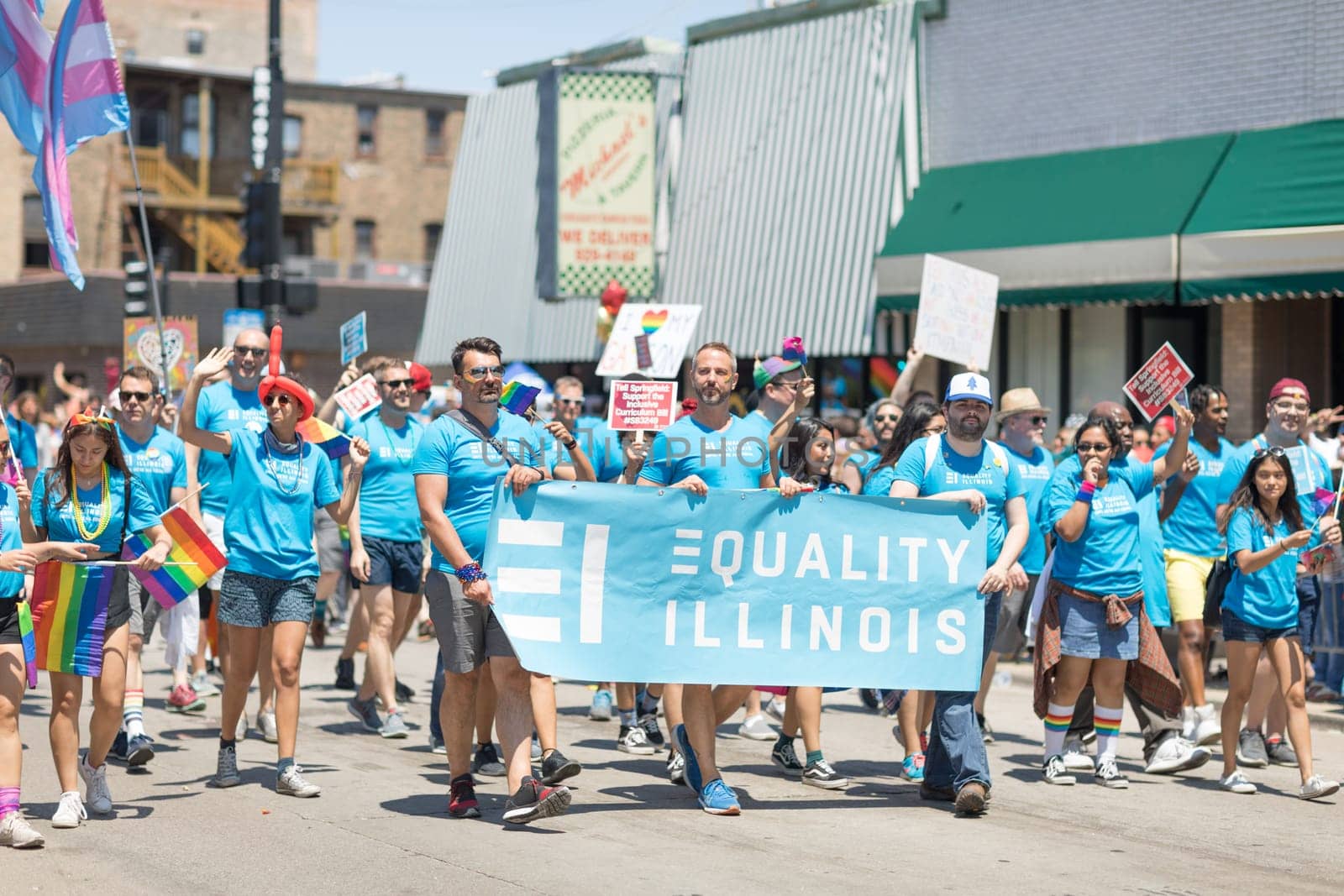 Chicago, Illinois, USA - June 24, 2018 People waving rainbow flags celebrating during the LGBTQ Pride Parade in Chicago