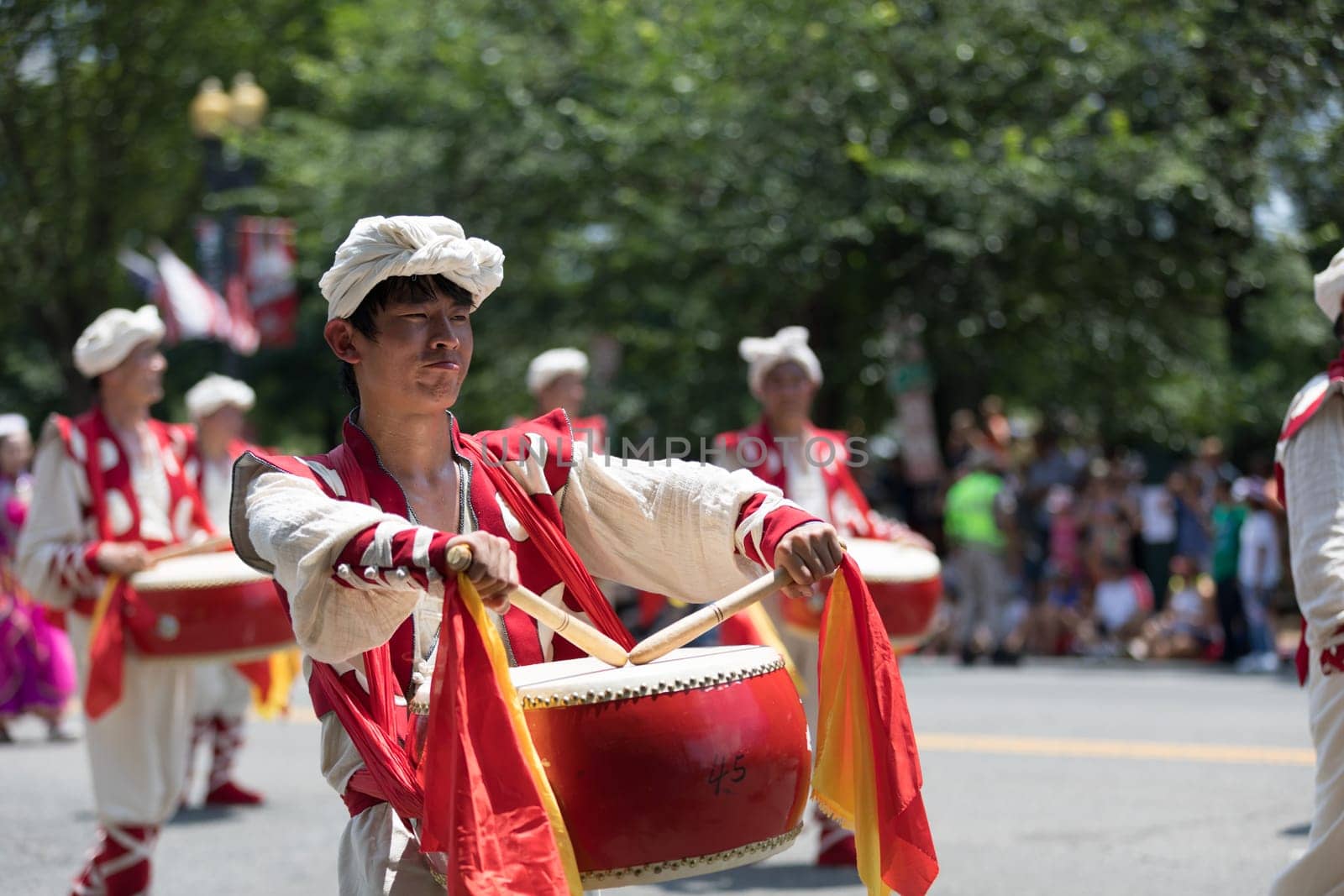 Washington, D.C., USA - July 4, 2018, The National Independence Day Parade, Chinese, wearing traditional clothing, playing drums, going down constitution avenue during the parade