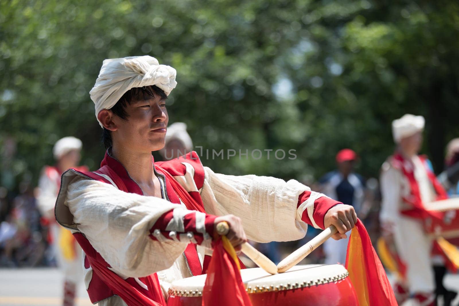 Washington, D.C., USA - July 4, 2018, The National Independence Day Parade, Chinese, wearing traditional clothing, playing drums, going down constitution avenue during the parade