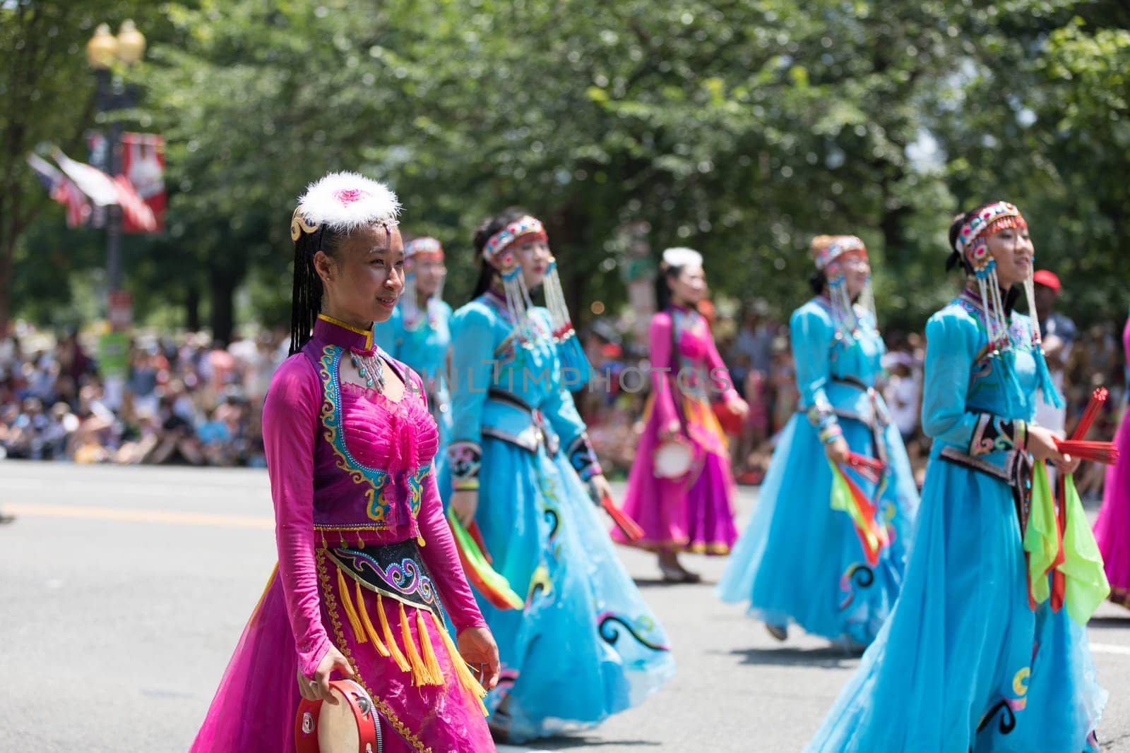 Washington, D.C., USA - July 4, 2018, The National Independence Day Parade, Chinese women wearing traditional clothing, walking down constitution avenue during the parade