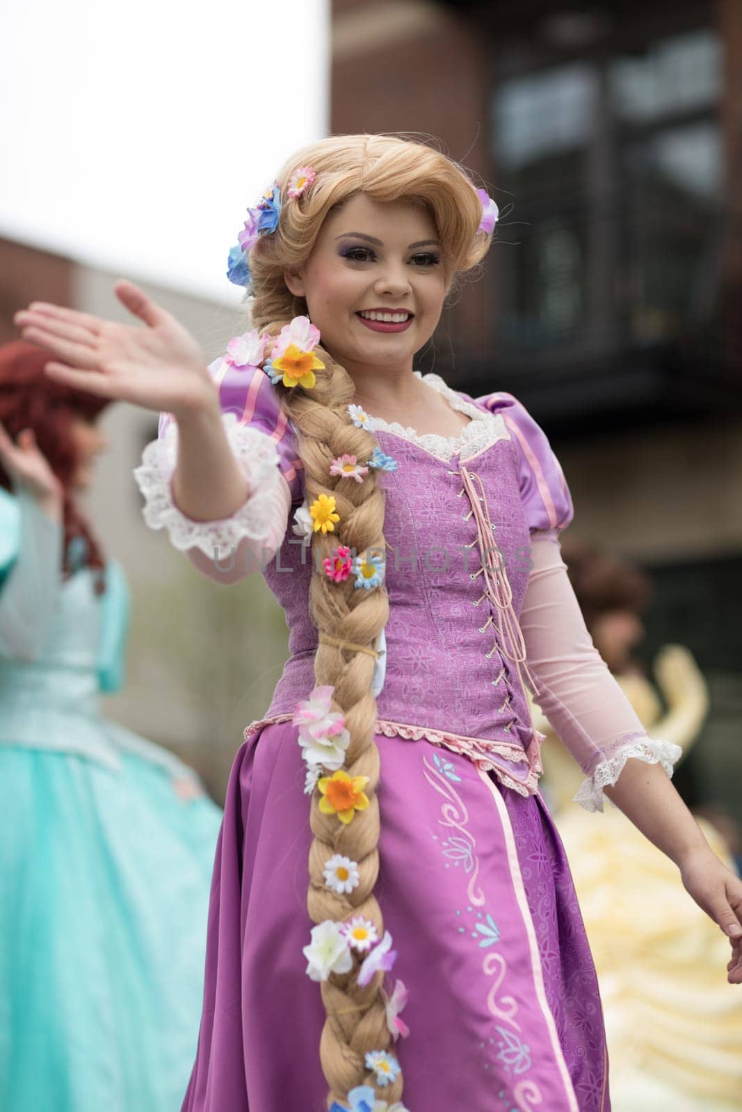 Holland, Michigan, USA - May 12, 2018 Members of Everafter West Michigan dress up as disney princess  at the Muziek Parade, during the Tulip Time Festival