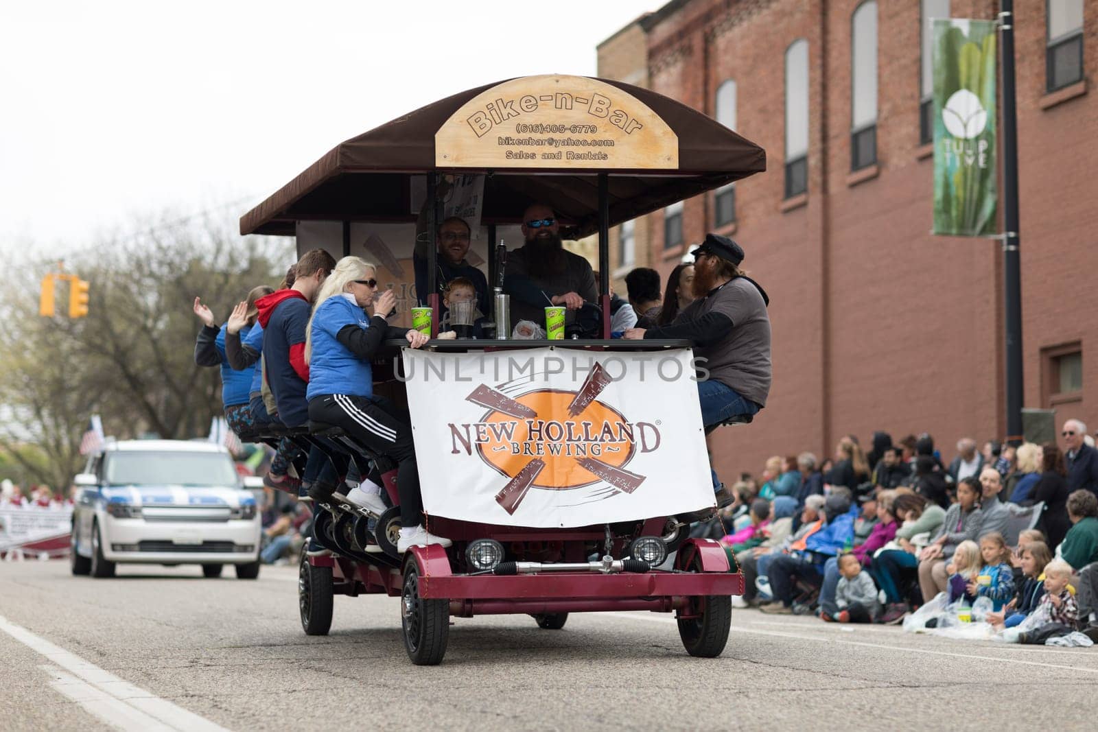 Holland, Michigan, USA - May 12, 2018 A Bike-n-Bar from new Holland Brewing going down the road at the Muziek Parade, during the Tulip Time Festival