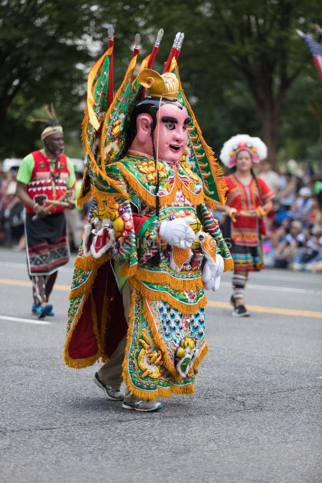Washington, D.C., USA - July 4, 2018, The National Independence Day Parade, Taiwanese man wearing traditional clothing and a mask, walking down constitution avenue
