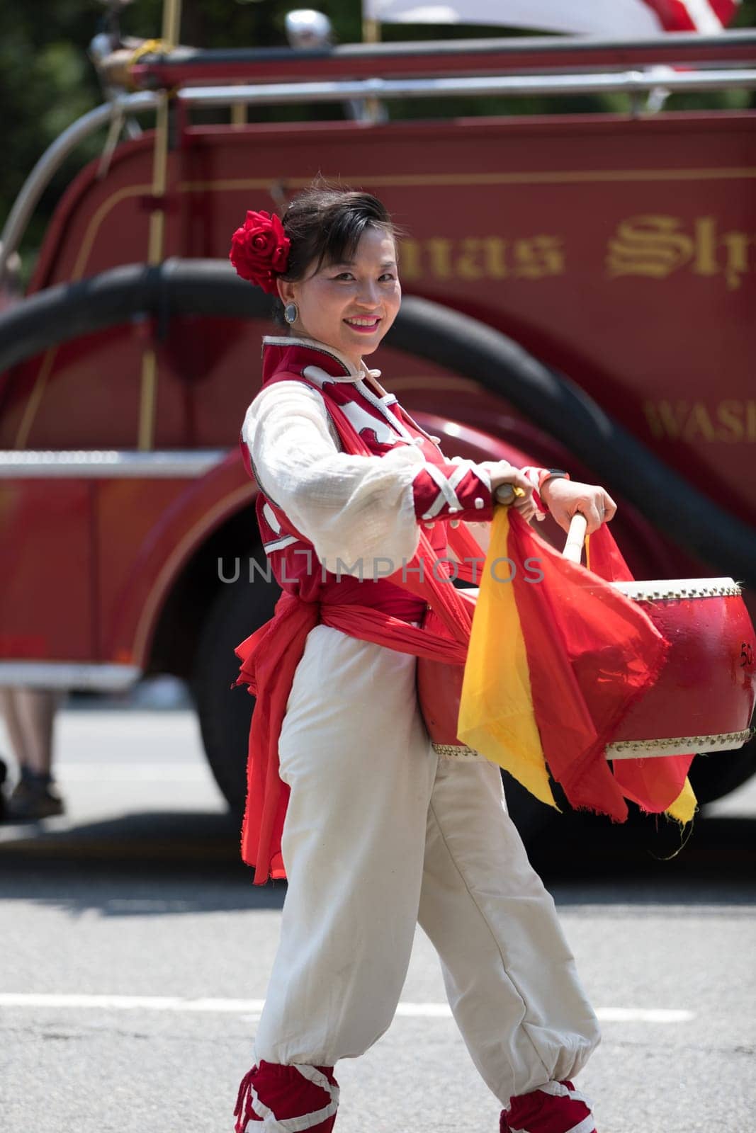 Washington, D.C., USA - July 4, 2018, The National Independence Day Parade, Chinese, wearing traditional clothing, playing drums, going down constitution avenue during the parade