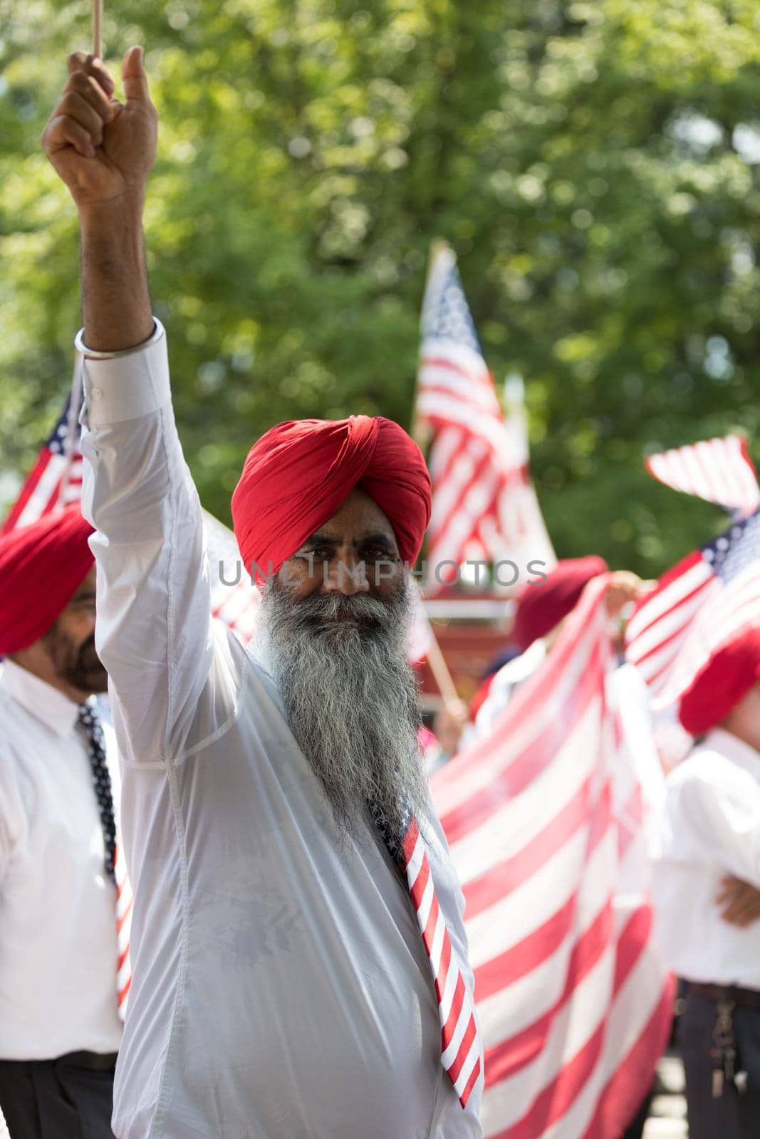 Washington, D.C., USA - July 4, 2018, The National Independence Day Parade, The Sikhs of America, waving american flags, going down constitution avenue during the parade