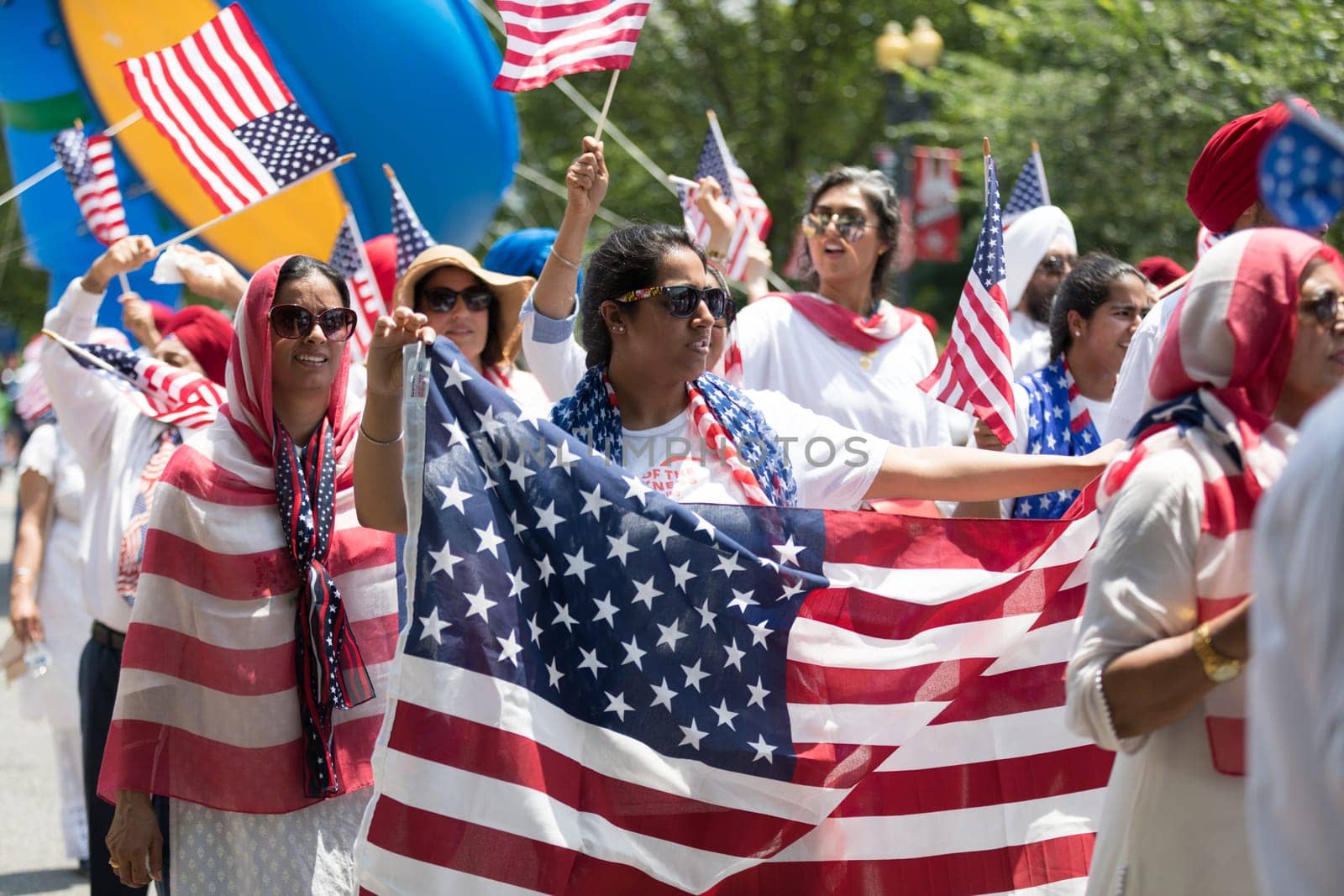 Washington, D.C., USA - July 4, 2018, The National Independence Day Parade, The Sikhs of America, waving american flags, going down constitution avenue during the parade