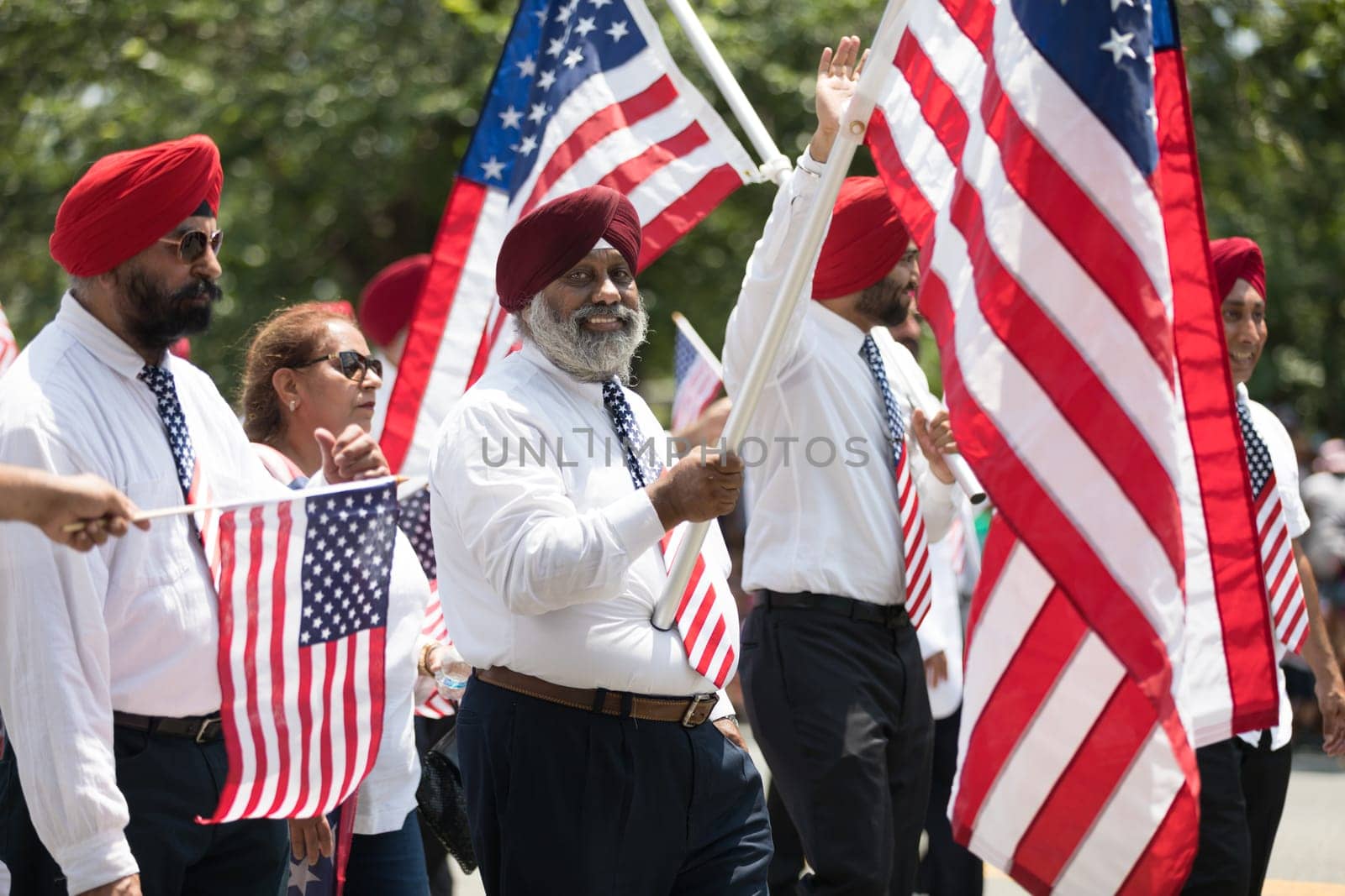 Washington, D.C., USA - July 4, 2018, The National Independence Day Parade, The Sikhs of America, waving american flags, going down constitution avenue during the parade