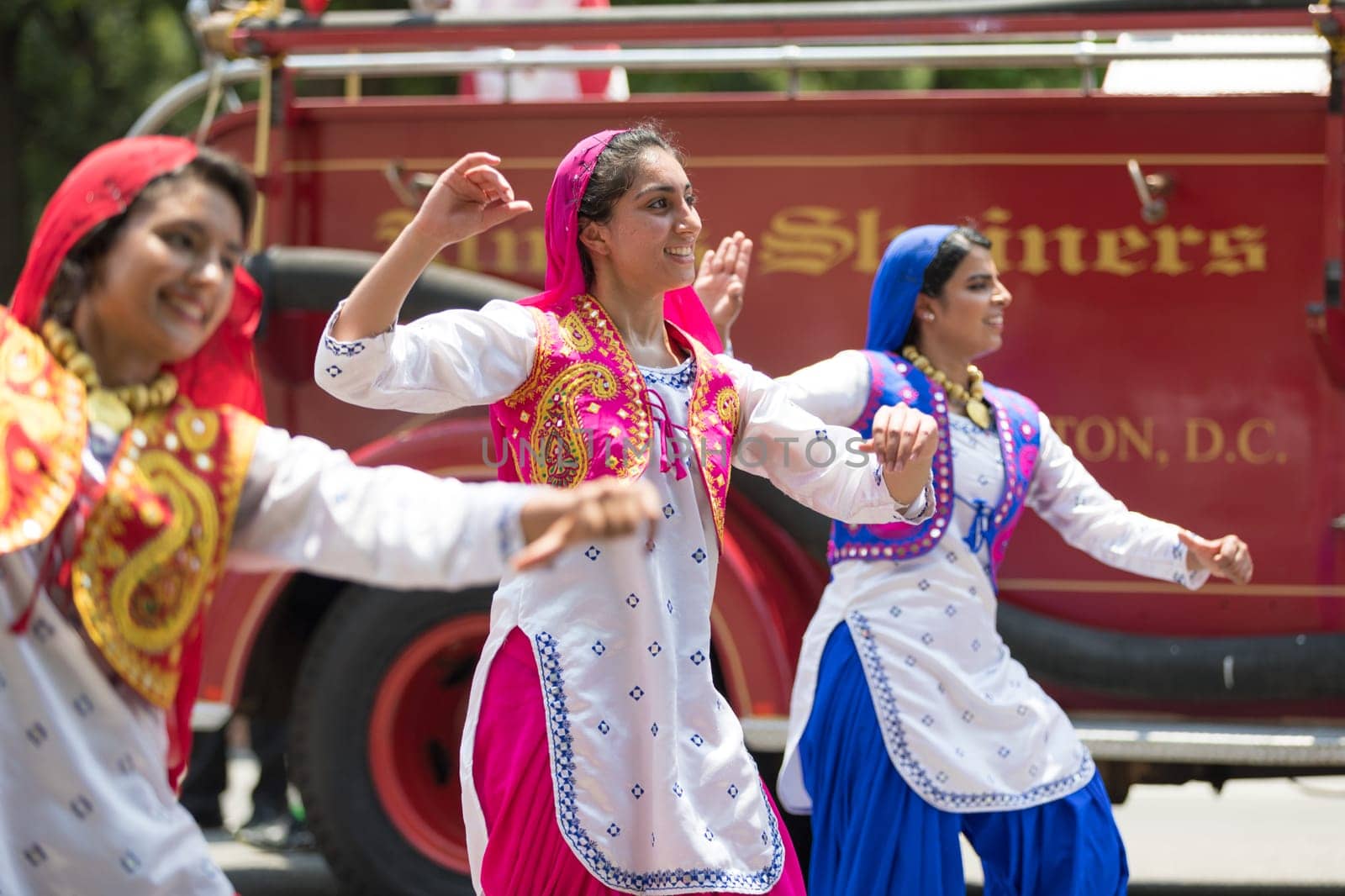 Washington, D.C., USA - July 4, 2018, The National Independence Day Parade, Indian women, dancers, wearing traditional clothing, going down constitution avenue