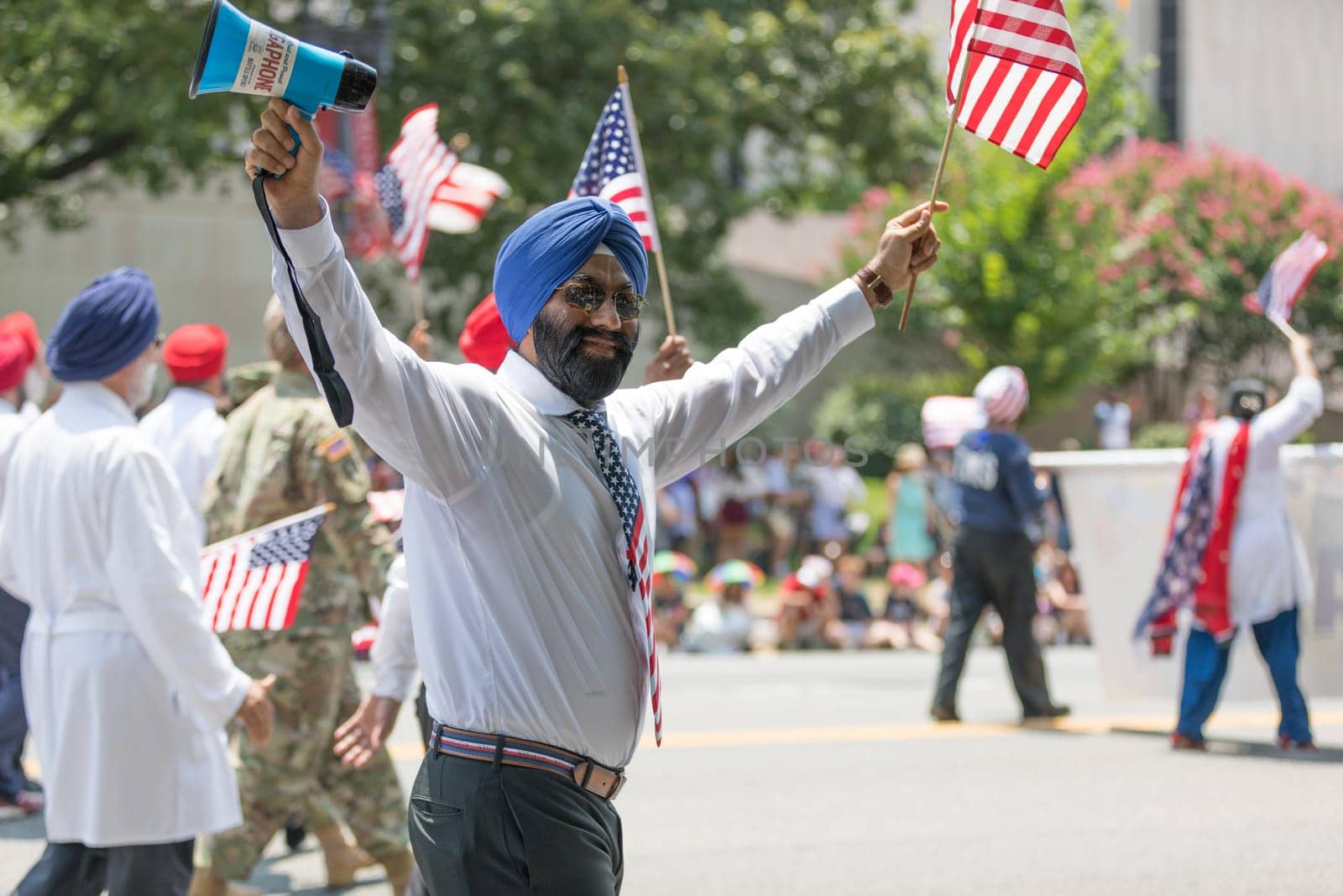 Washington, D.C., USA - July 4, 2018, The National Independence Day Parade, The Sikhs of America, waving american flags, going down constitution avenue during the parade