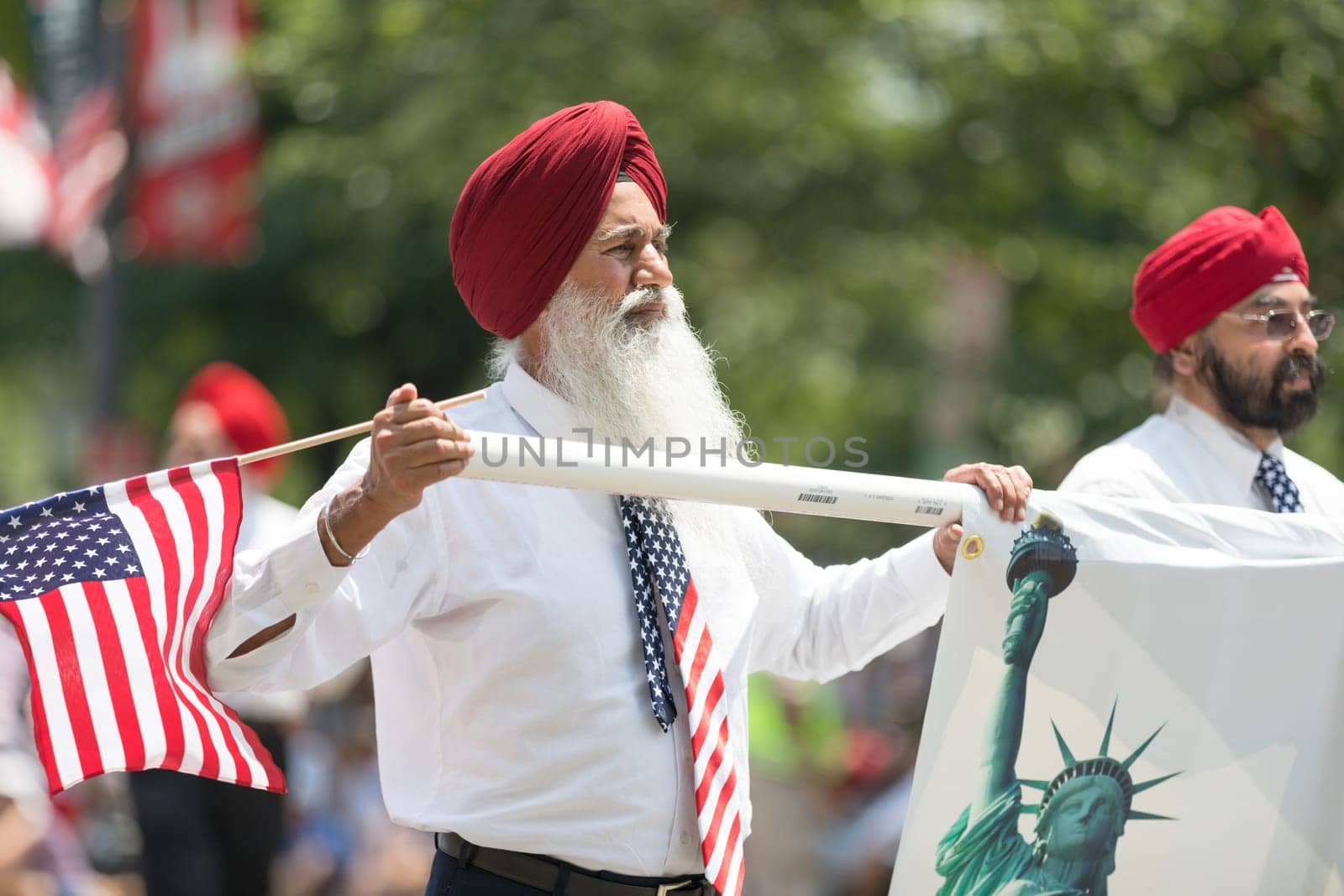 Washington, D.C., USA - July 4, 2018, The National Independence Day Parade, The Sikhs of America, waving american flags, going down constitution avenue during the parade