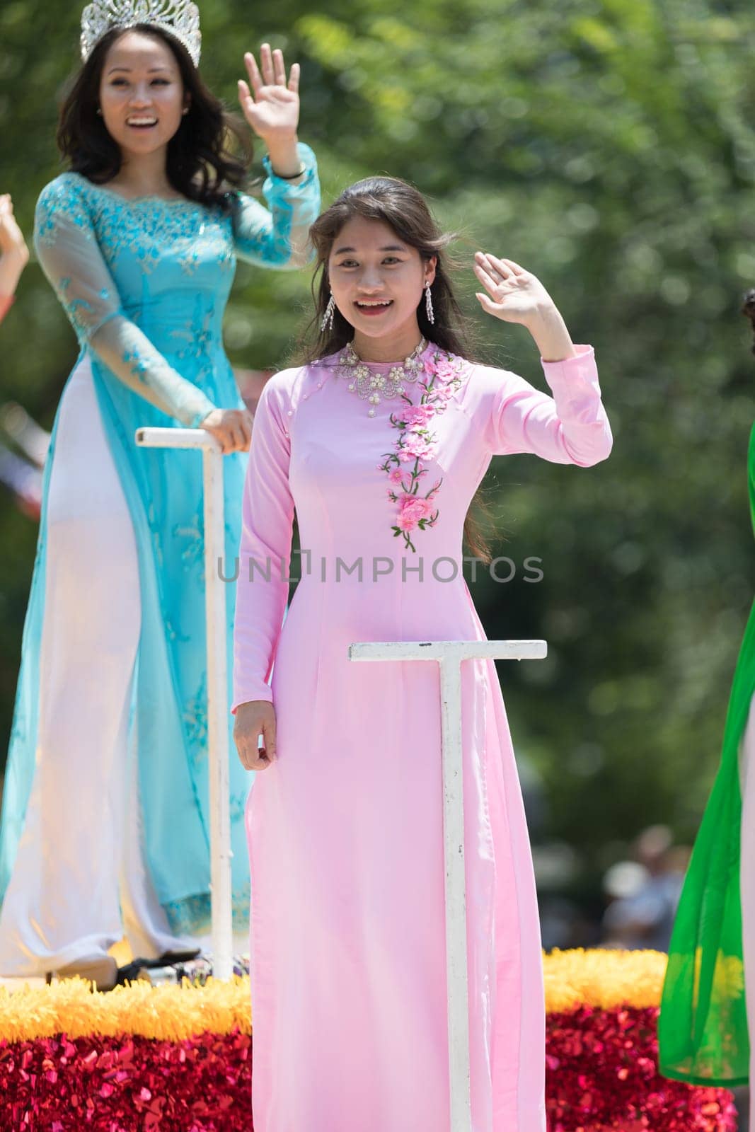 Washington, D.C., USA - July 4, 2018, The National Independence Day Parade, Vietnamese American women wearing traditional dresses, going down constitution avenue