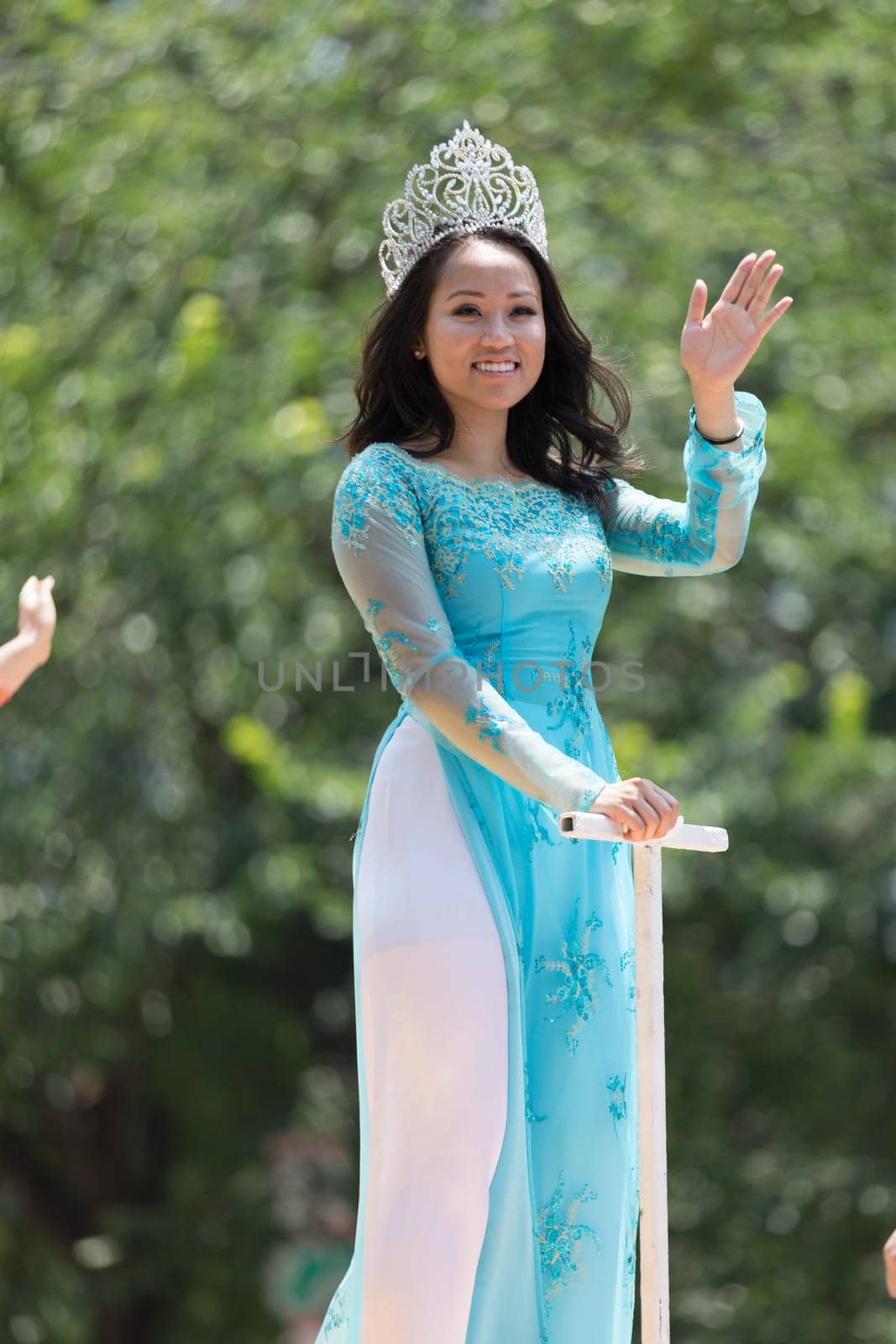 Washington, D.C., USA - July 4, 2018, The National Independence Day Parade, Vietnamese American women wearing traditional dresses, going down constitution avenue