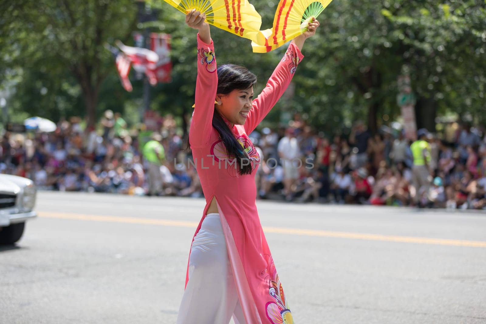 Washington, D.C., USA - July 4, 2018, The National Independence Day Parade, Vietnamese American women wearing traditional dresses, going down constitution avenue
